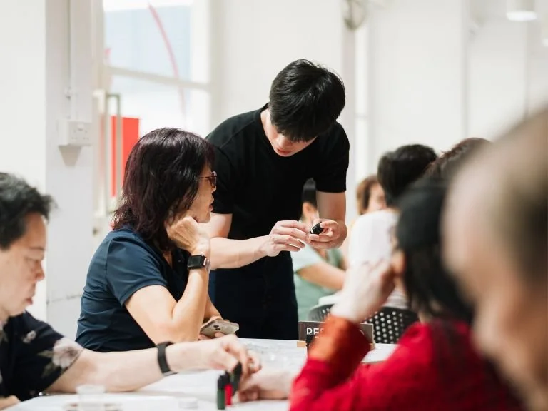 Corporate volunteers engaging seniors in an intergenerational CSR activity in Singapore