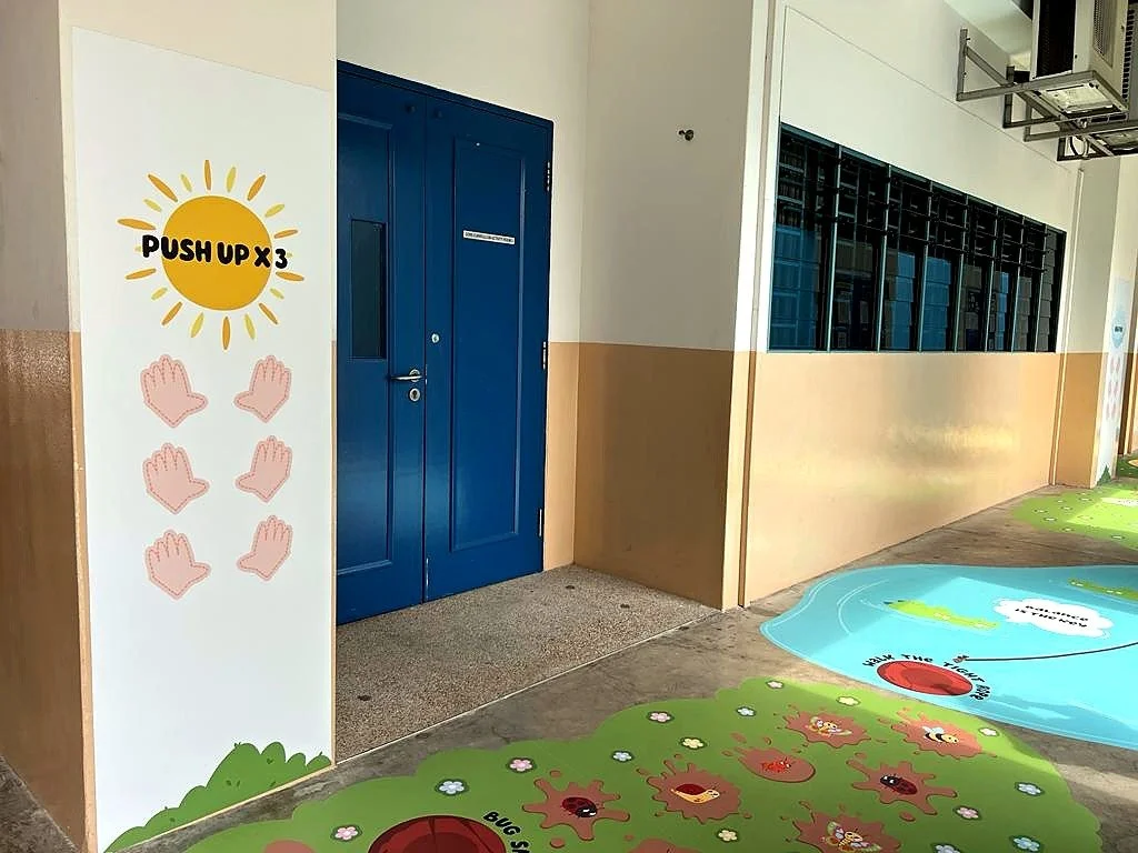 Wall push-up activity along a school sensory trail designed to provide proprioceptive movement input for students