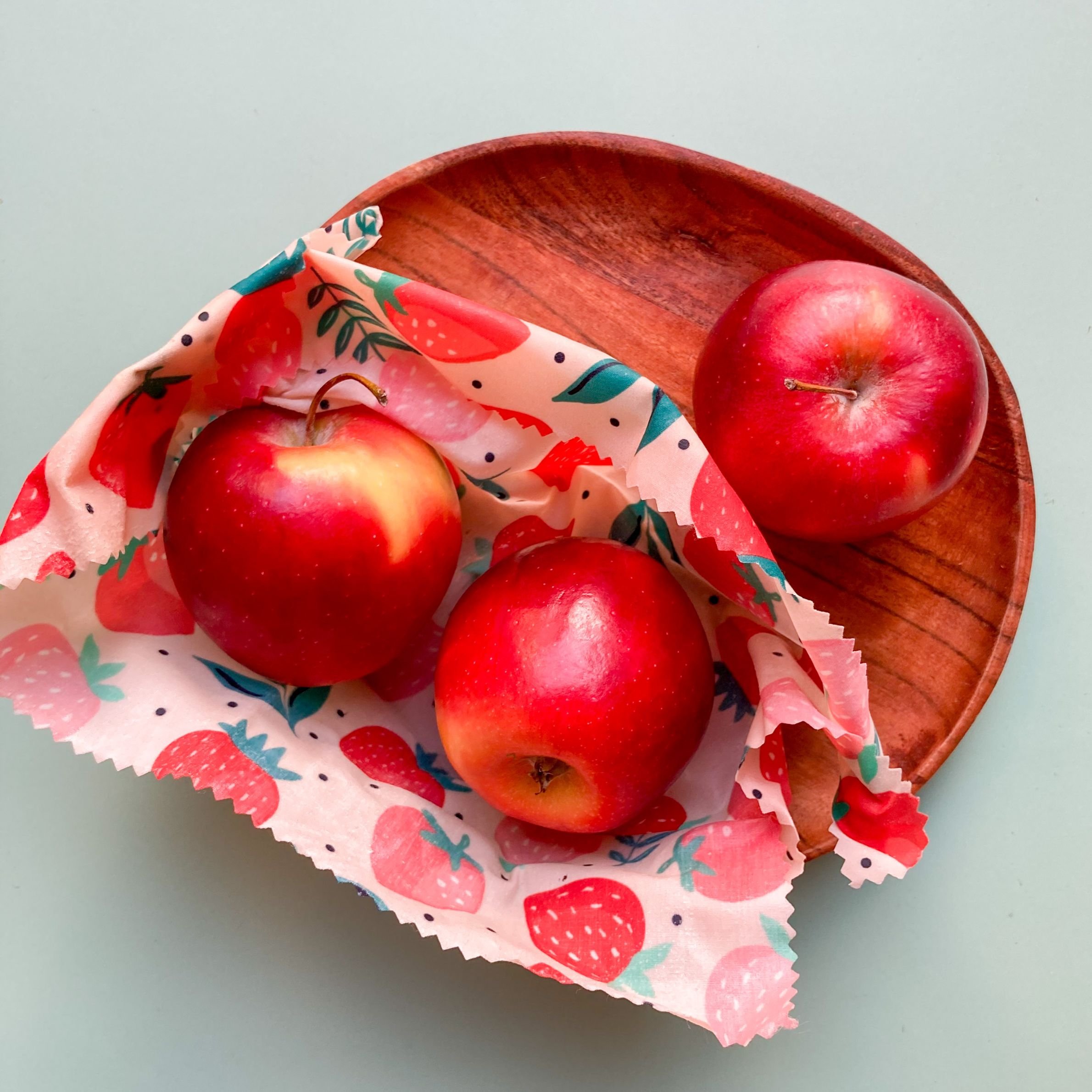 Participants making reusable beeswax wraps at an eco festival workshop in Singapore.