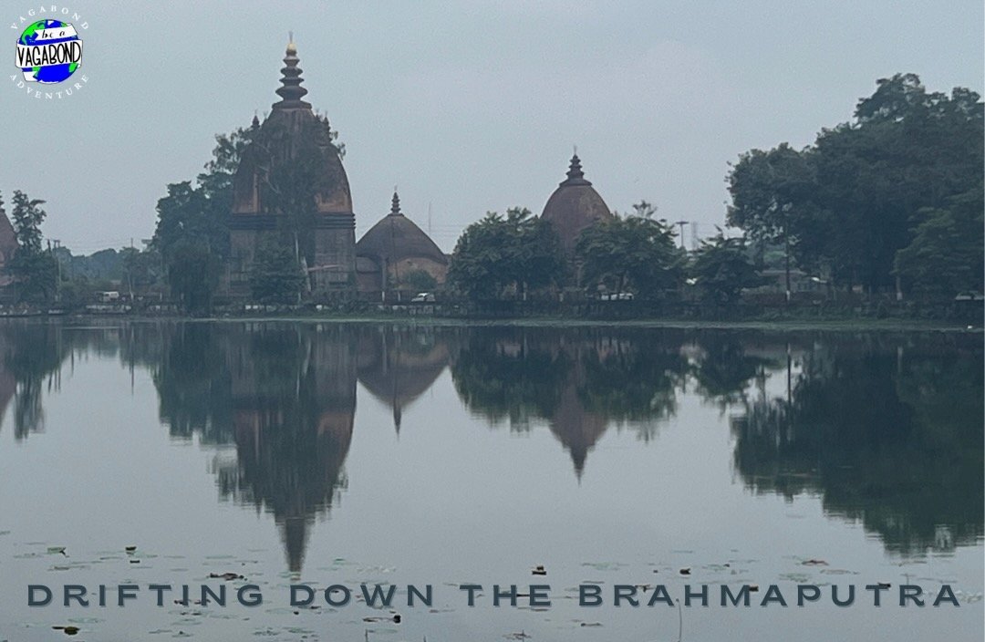 Domed buildings reflected in a still Brahmaputra river.