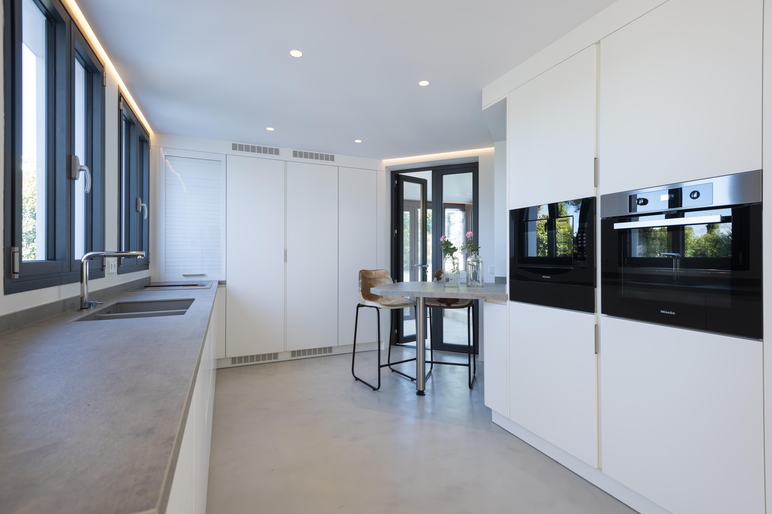 The kitchen features Miele appliances including wine cooler. There is an adjacent utility room with Miele washing machine and dryer.