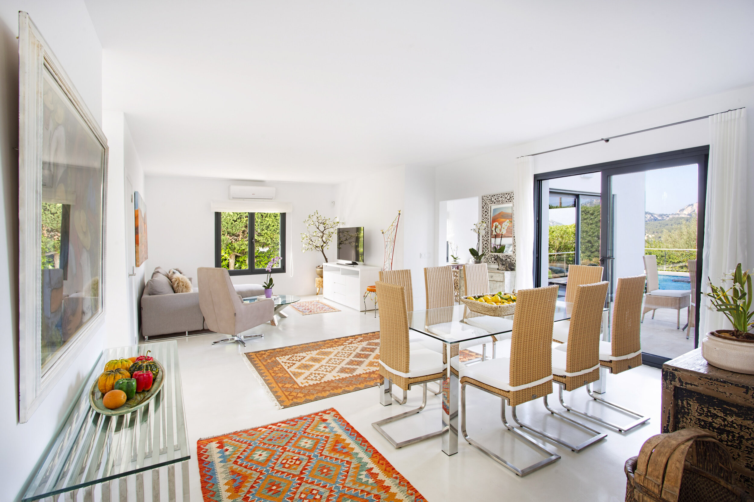 This light filled living and dining room looks out on to the pool and garden area.