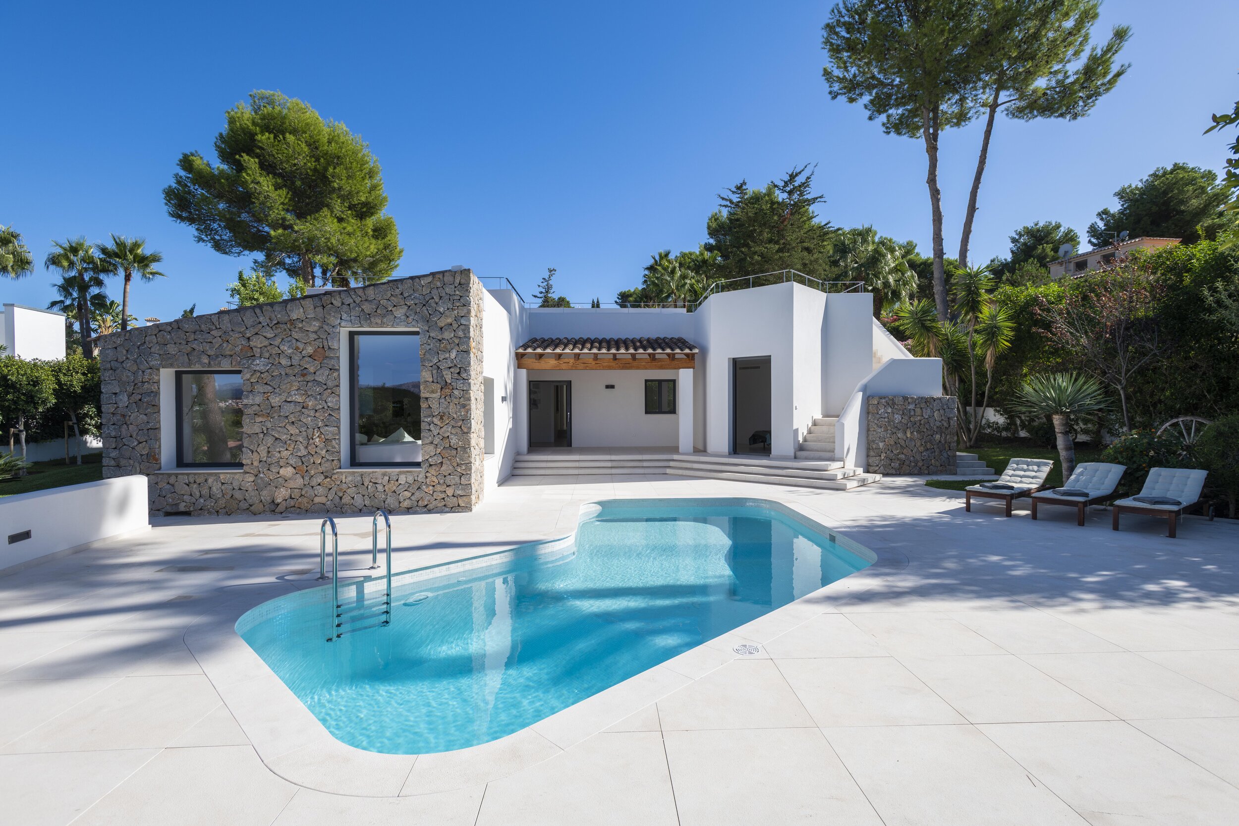 The tiles featured are blanco crema natural stone placed strategically and ethically to direct the water into the garden.