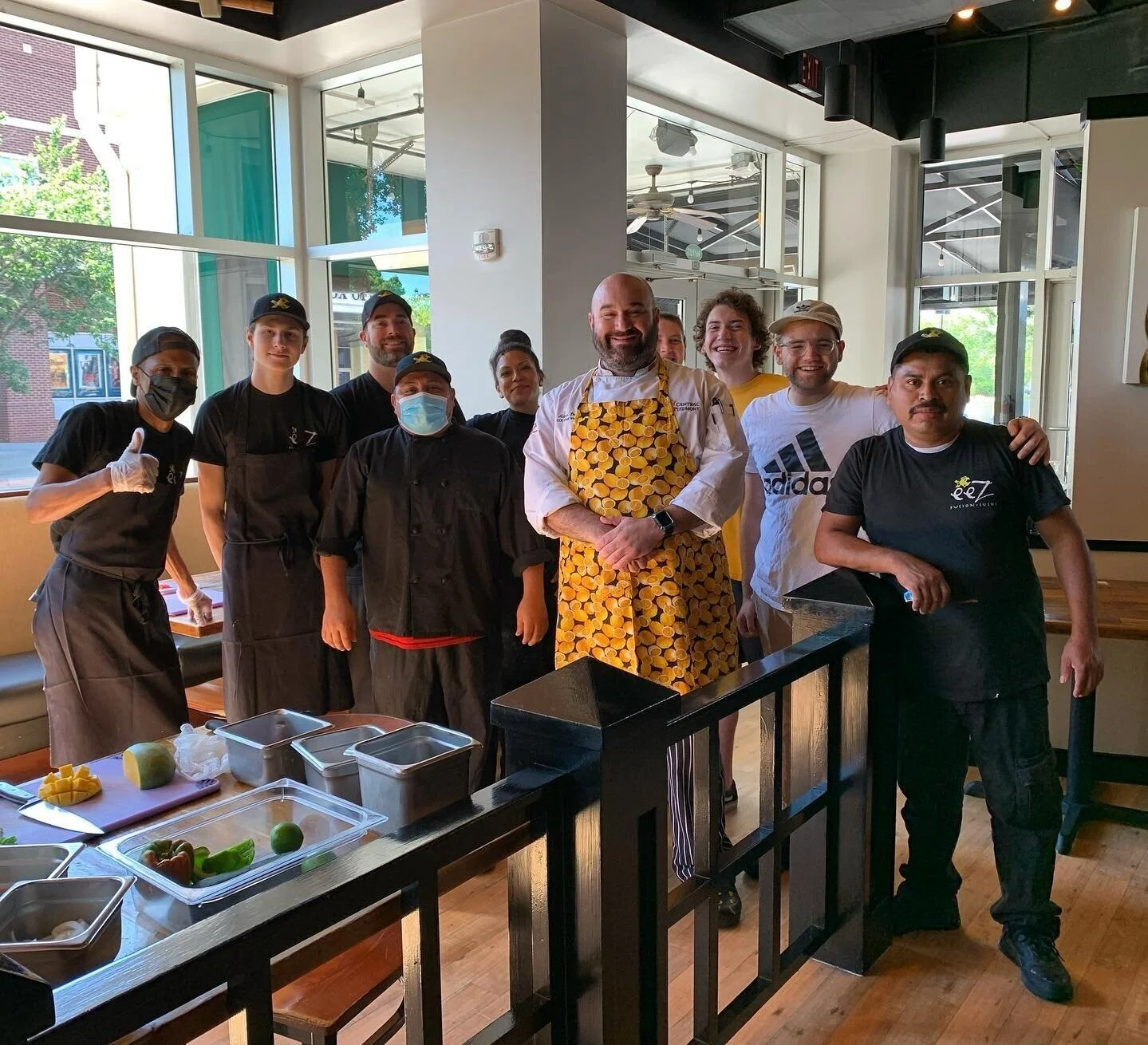 happy servsafe certified students after a food safety class inside of restaurant