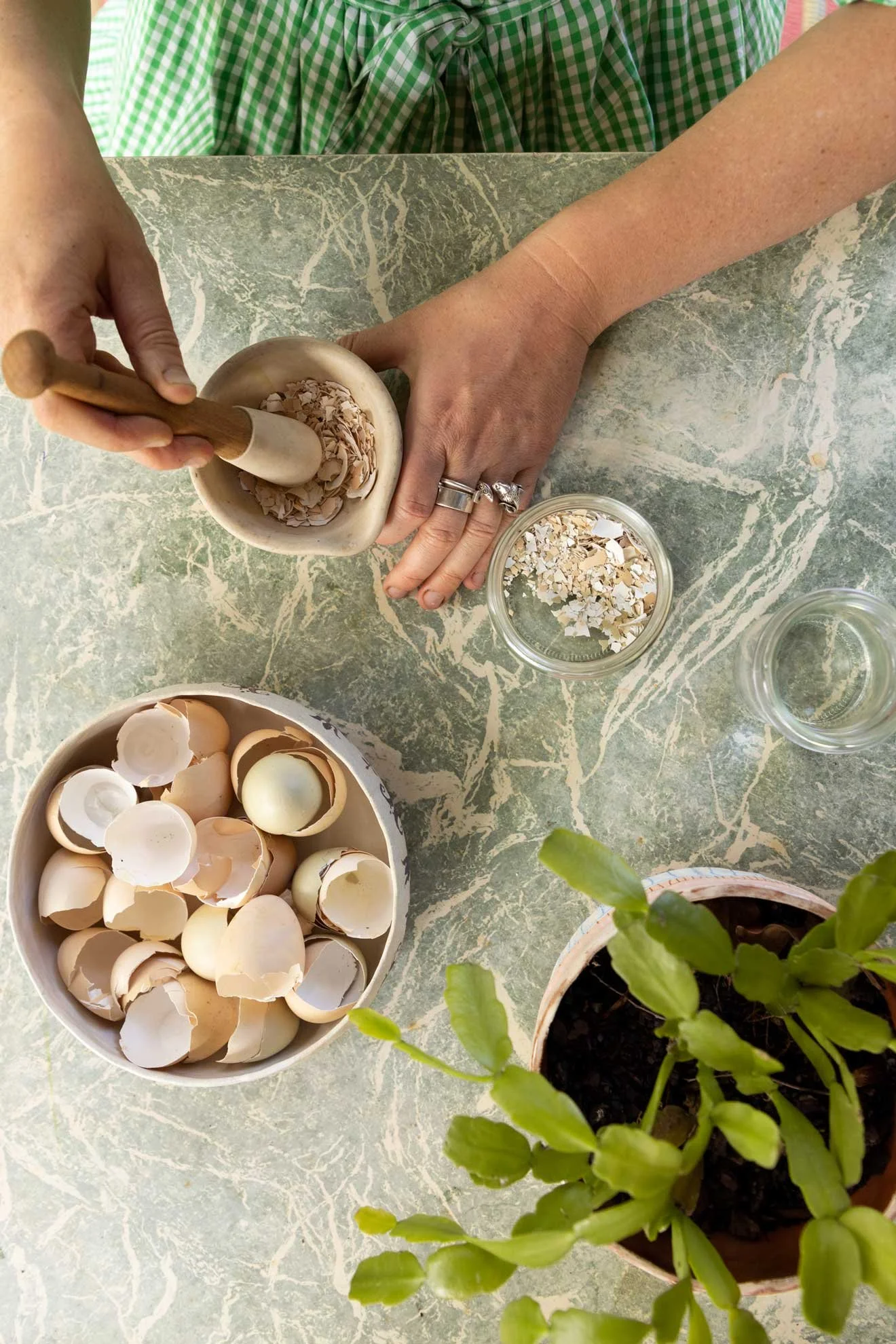 Photo of Compostable Kate using nettle and eggshell to make a planet tonic for 'The Compost Coach Book' photographed by Honey Atkinson