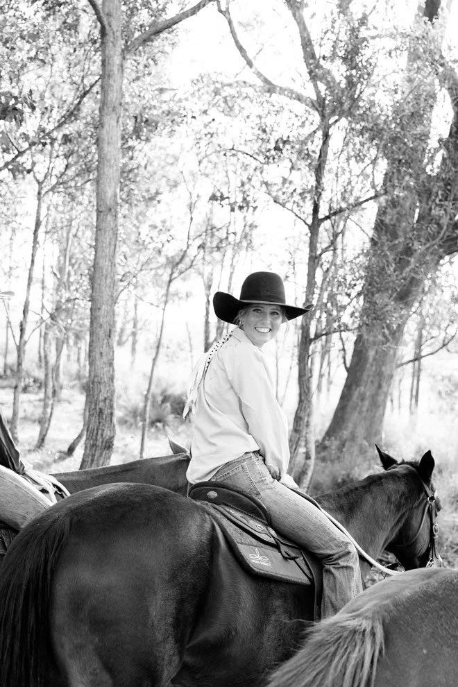 Black and white brand photography, Sophie of Reins to Resilience on horseback among gum trees, Bega Valley NSW