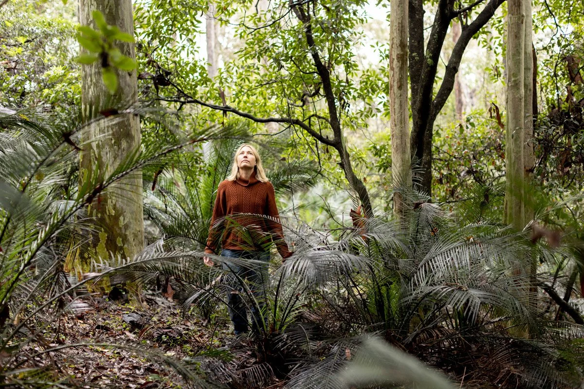 Honey Atkinson the photographer standing pondering in the spotted gum forest in the far south coast nsw