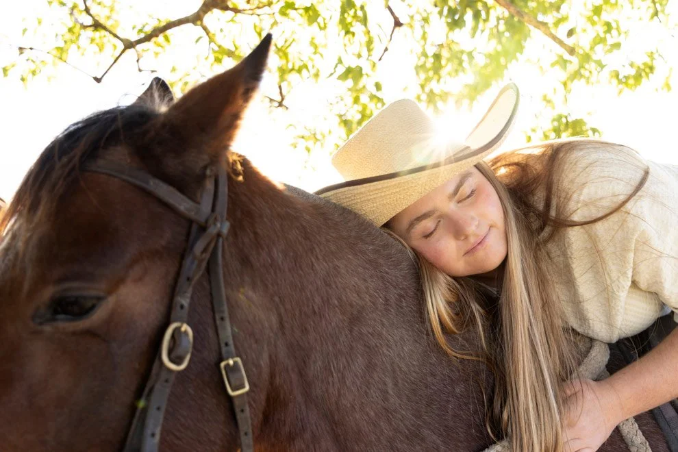 Personal brand photography, teenage participant resting with horse at Reins to Resilience equine resilience program, Candelo Bega Valley NSW