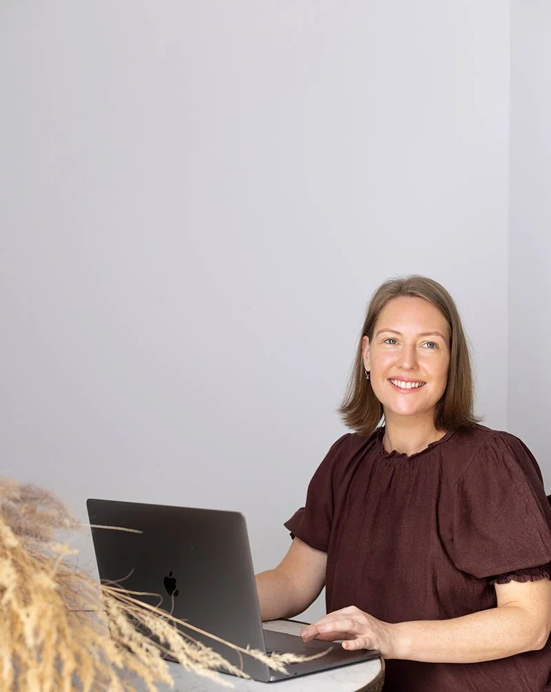 Career alignment practitioner Samantha sitting at computer sharing her advice