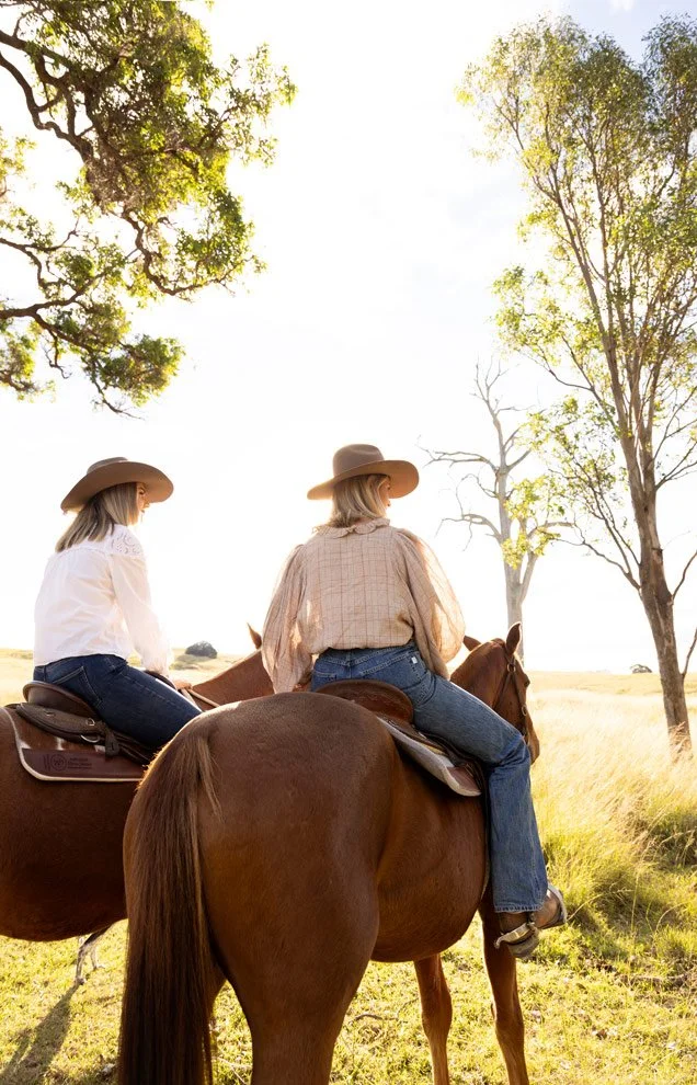 Personal brand photography for women in business, Sophie and Gen of Reins to Resilience riding horses through golden light, Candelo NSW
