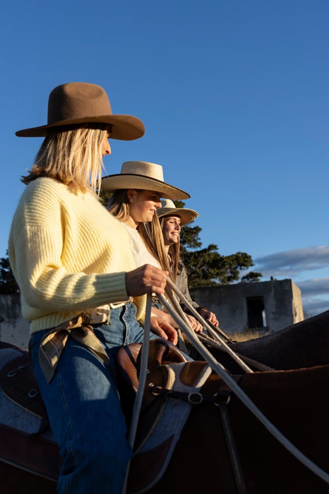 Personal brand photography Sapphire Coast, Gen and participants on horseback beside historic homestead ruins at golden hour, Reins to Resilience Candelo NSW