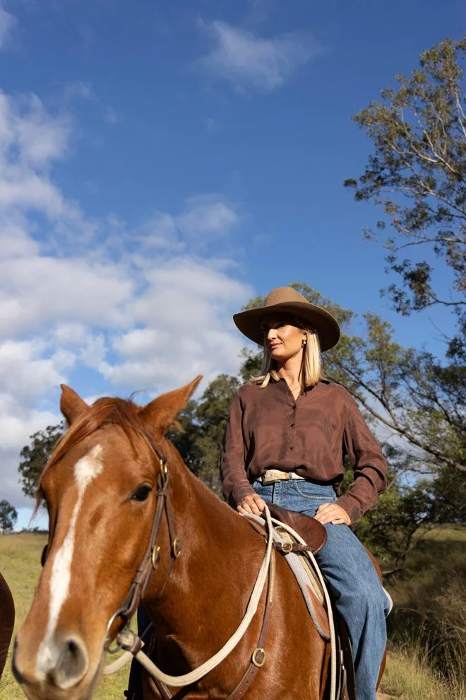 Personal brand photography, Gen of Reins to Resilience on horseback under blue sky, Candelo NSW Sapphire Coast