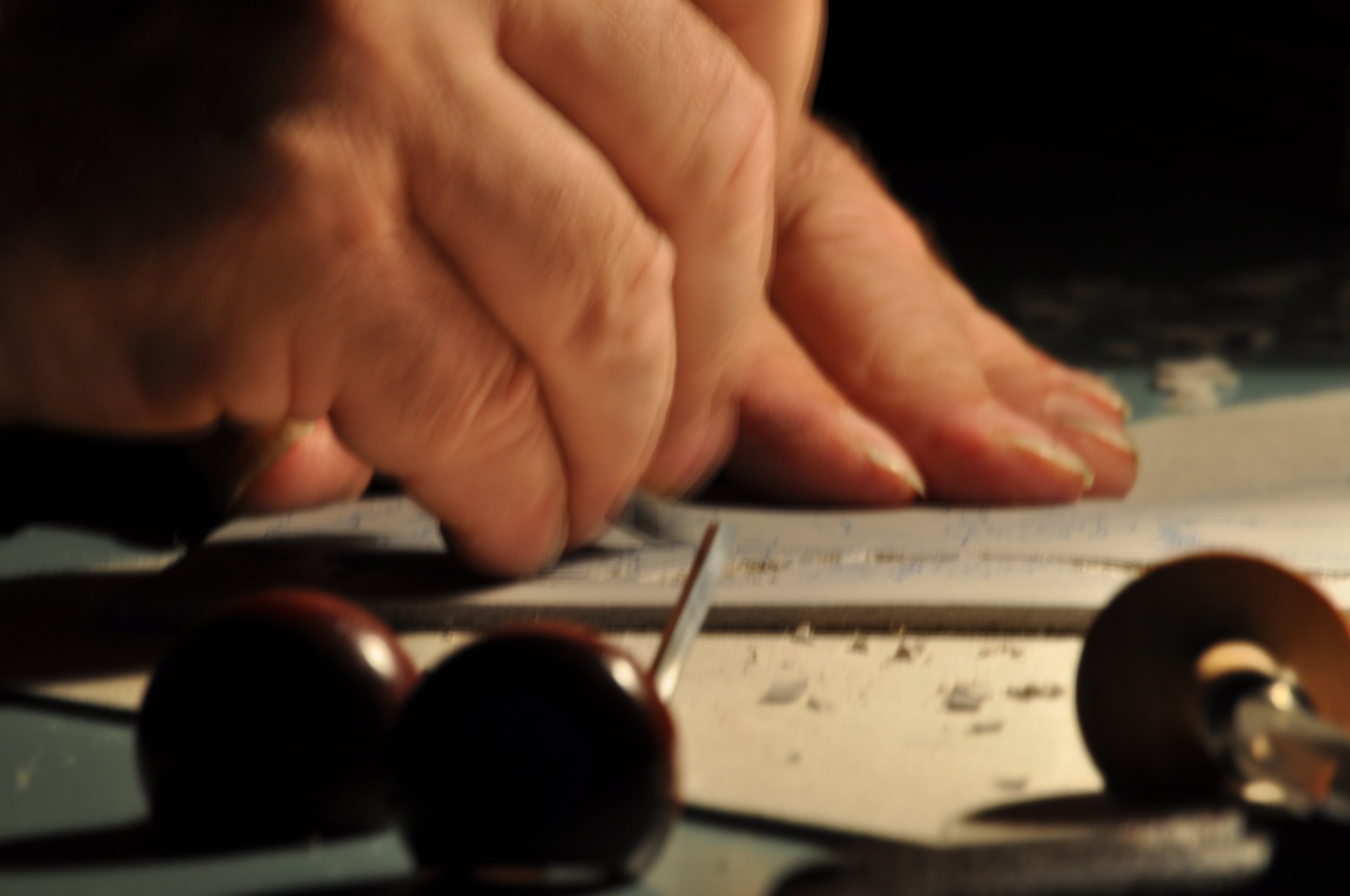 Paul Sharrock carefully cutting a linocut block.