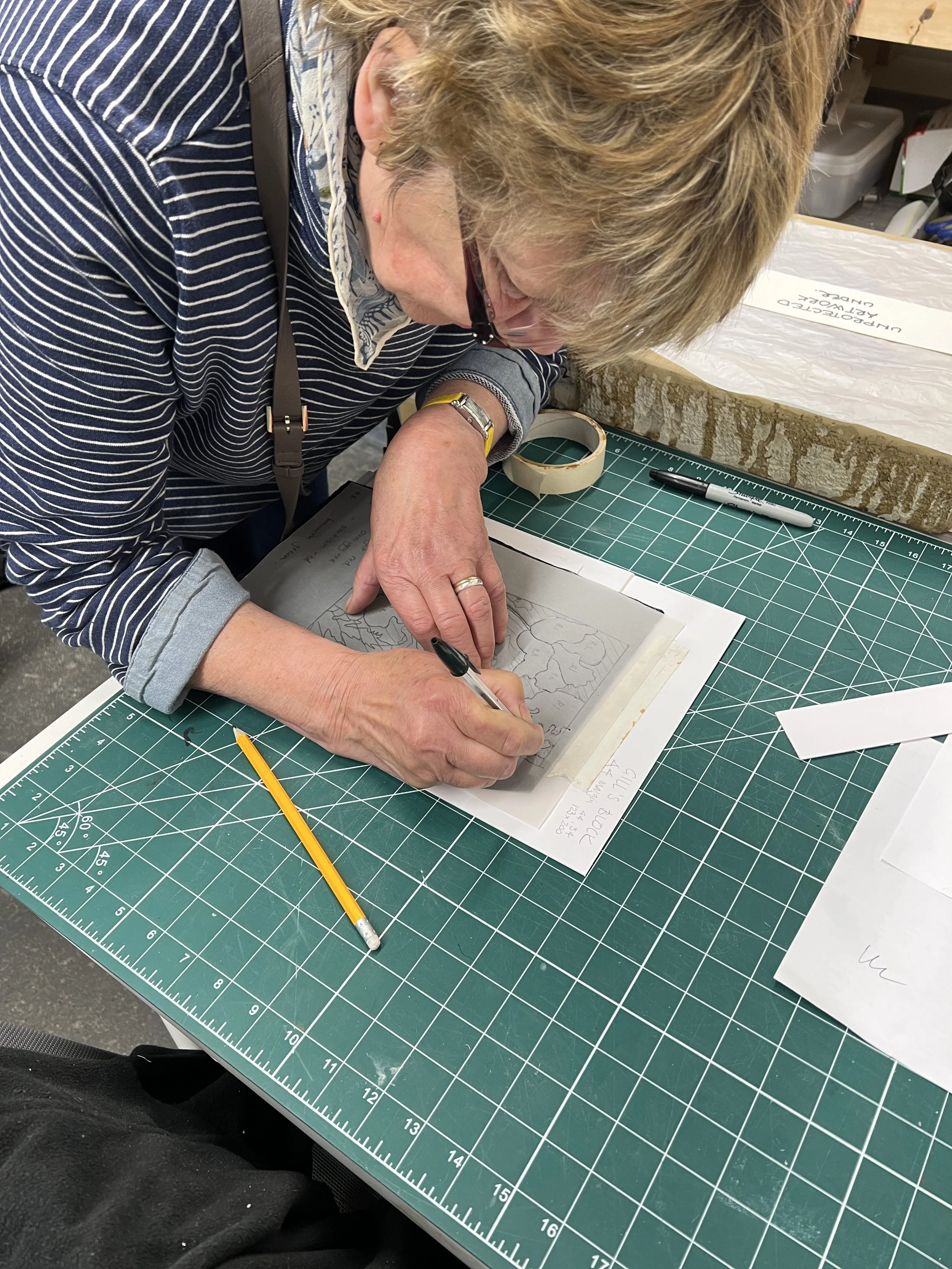 Transferring an image onto the linocut block ready for cutting.