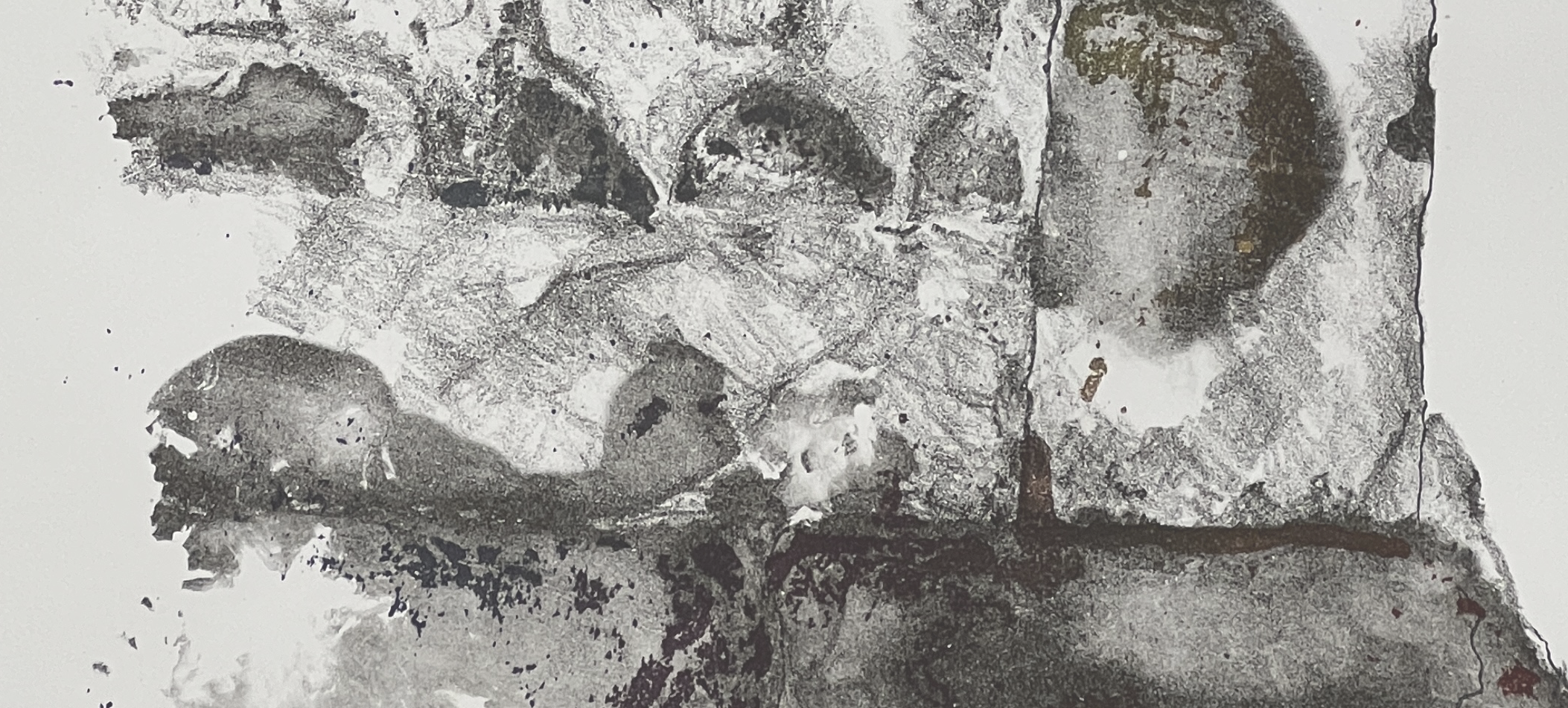 A black and white close-up of a textured surface, possibly a rock or mineral, with various patterns and cracks.