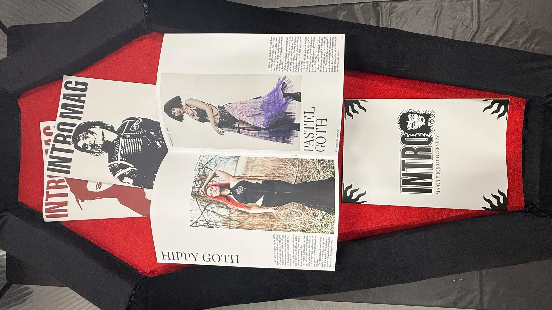 Open spread of Gothic magazine placed inside a display coffin.