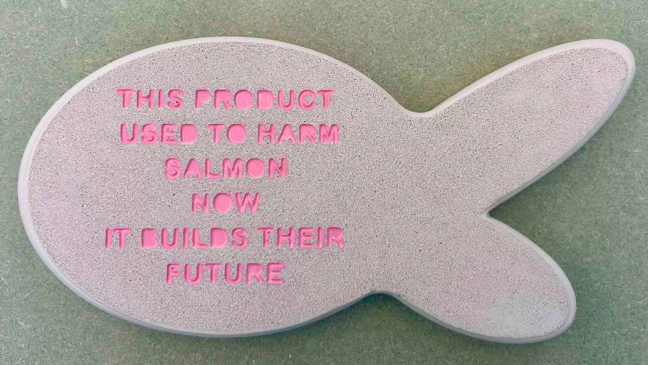 Plaster prototype with painted embossed lettering, exploring form, texture, and material identity.