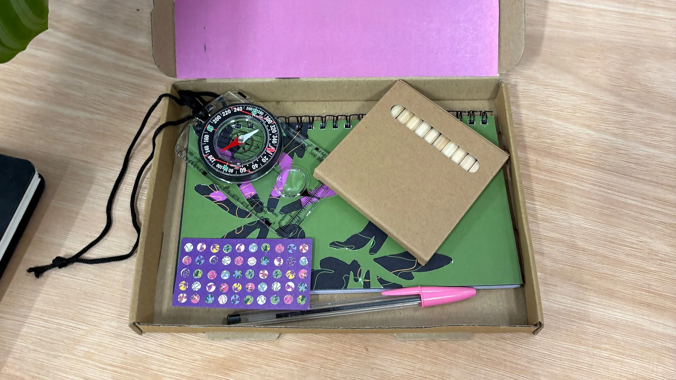 Booklet comes inside box with pencils, a pen, a magnifying glass and stickers.