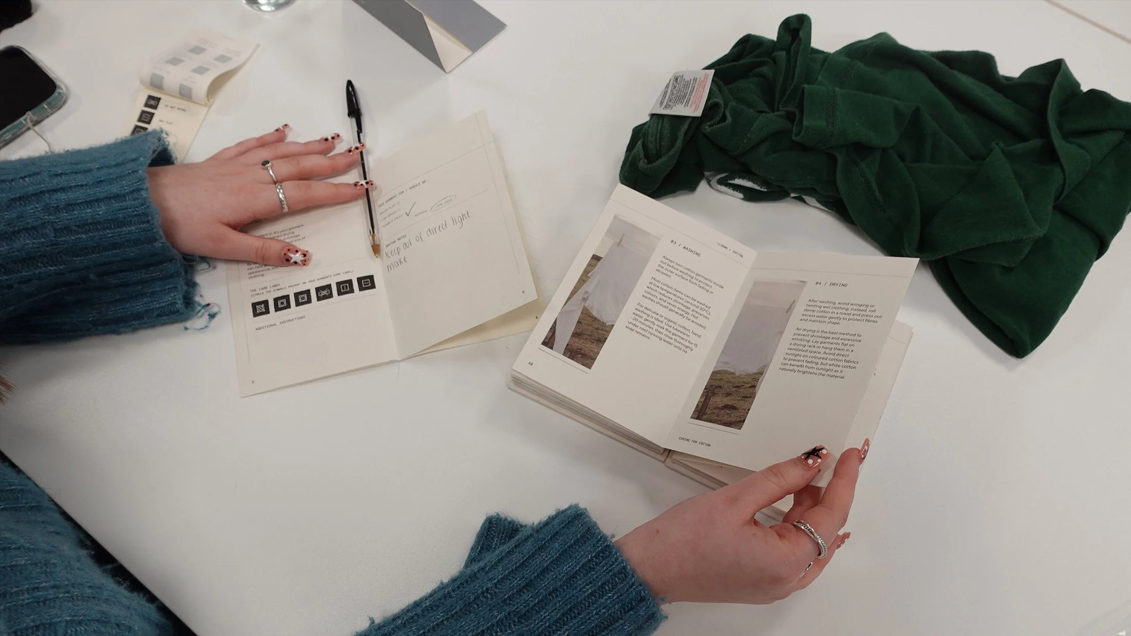A workshop participant using one of the books to complete their garment care booklet.