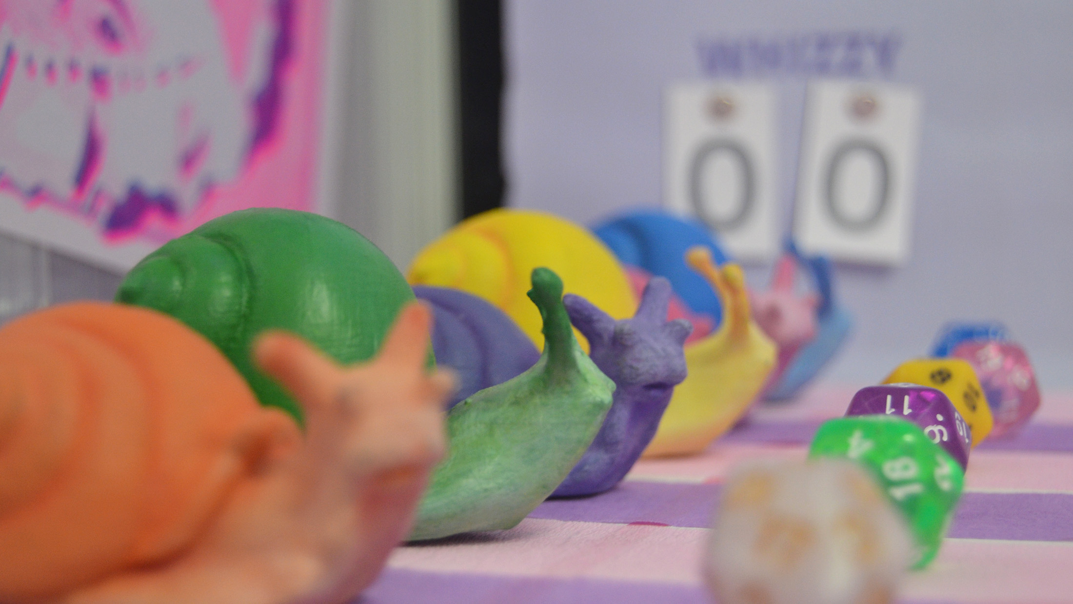 3D printed snails & D20 on race track.