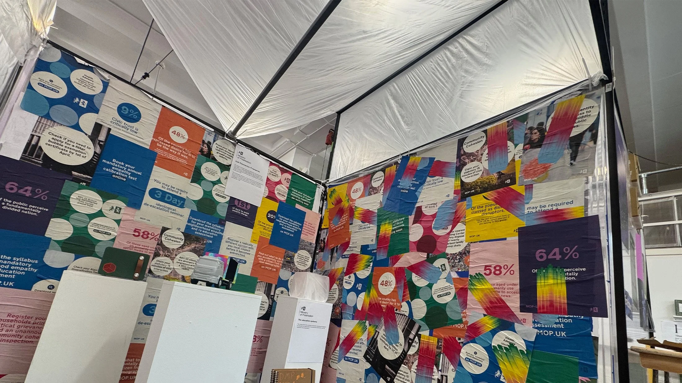 Welcome to the MOP.UK degree show stand. I wanted to establish the satirical premise of the project, showcasing the stark visual contrast between the rigid, traditional GOV.UK identity and my vibrant, subverted Ministry of Polarisation posters. 