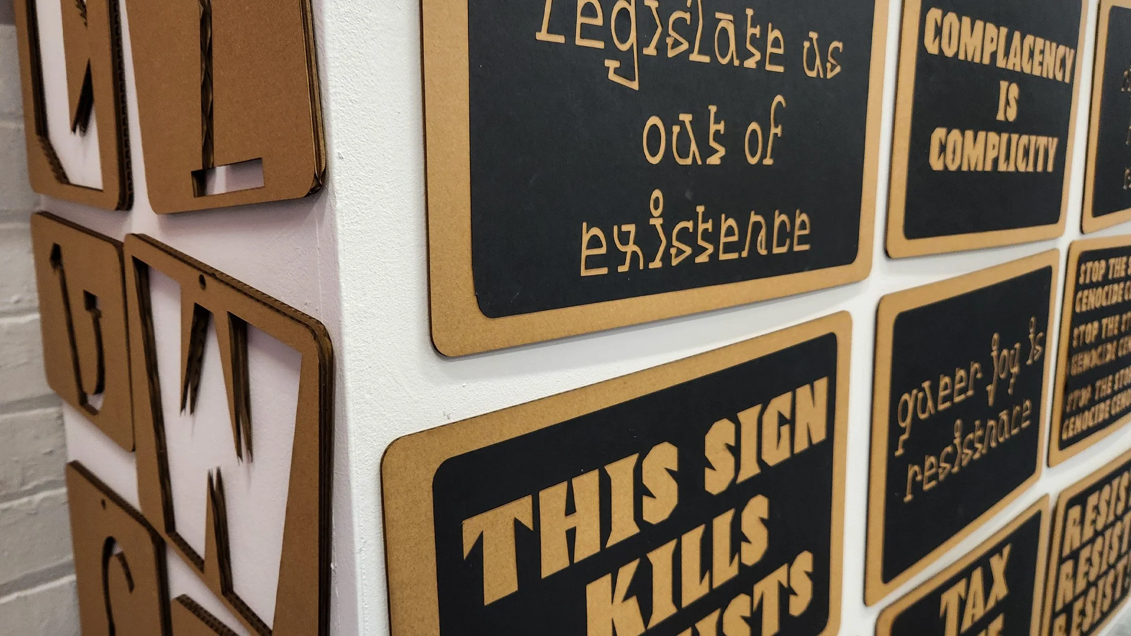 Papercut protest signs made using the fonts.