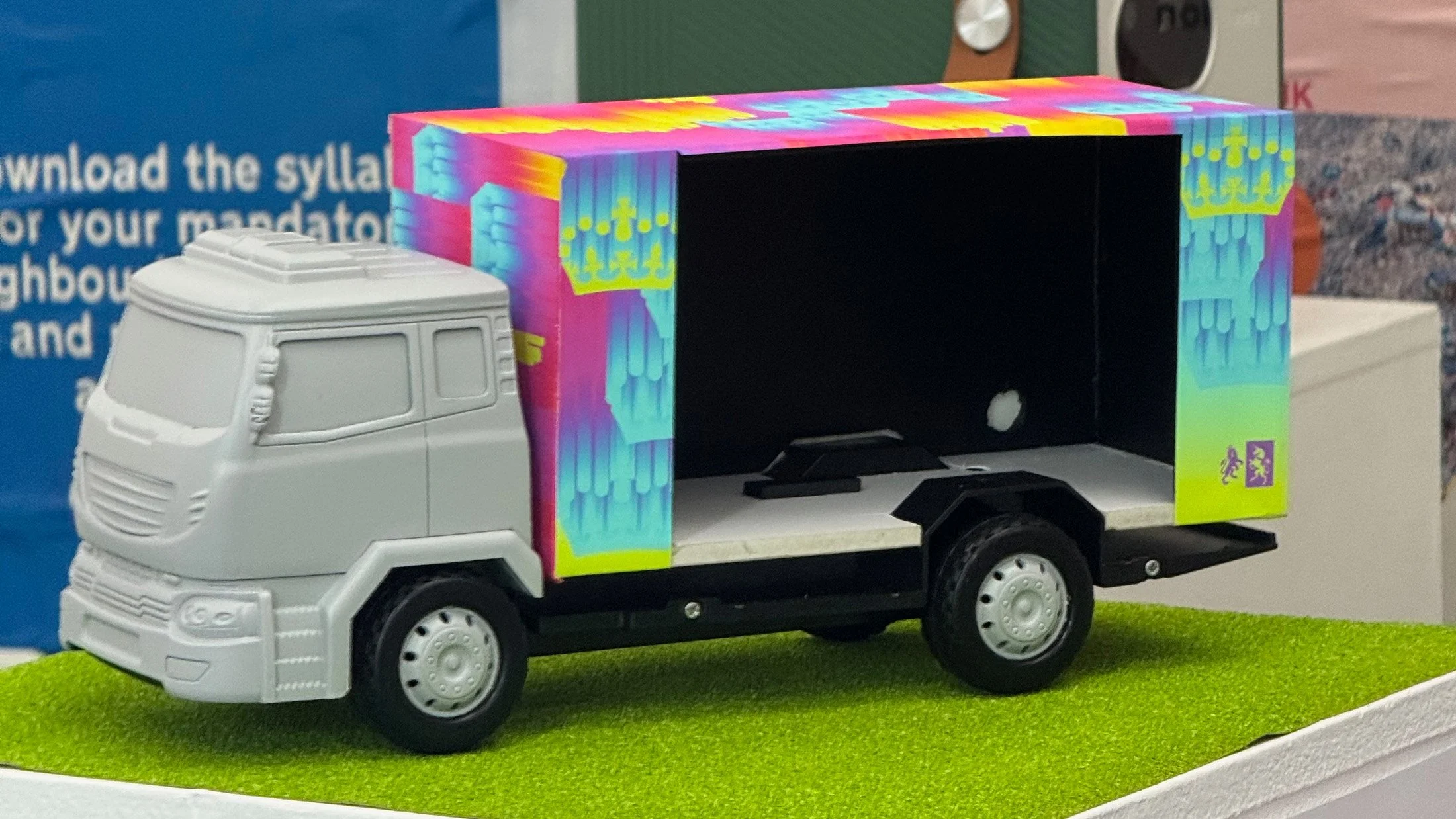 A detailed view of the scale-model mobile outreach unit. This truck represents a tangible future vision for MOP.UK, designed to take these interactive, educational experiences out of the gallery and directly into communities across the UK.