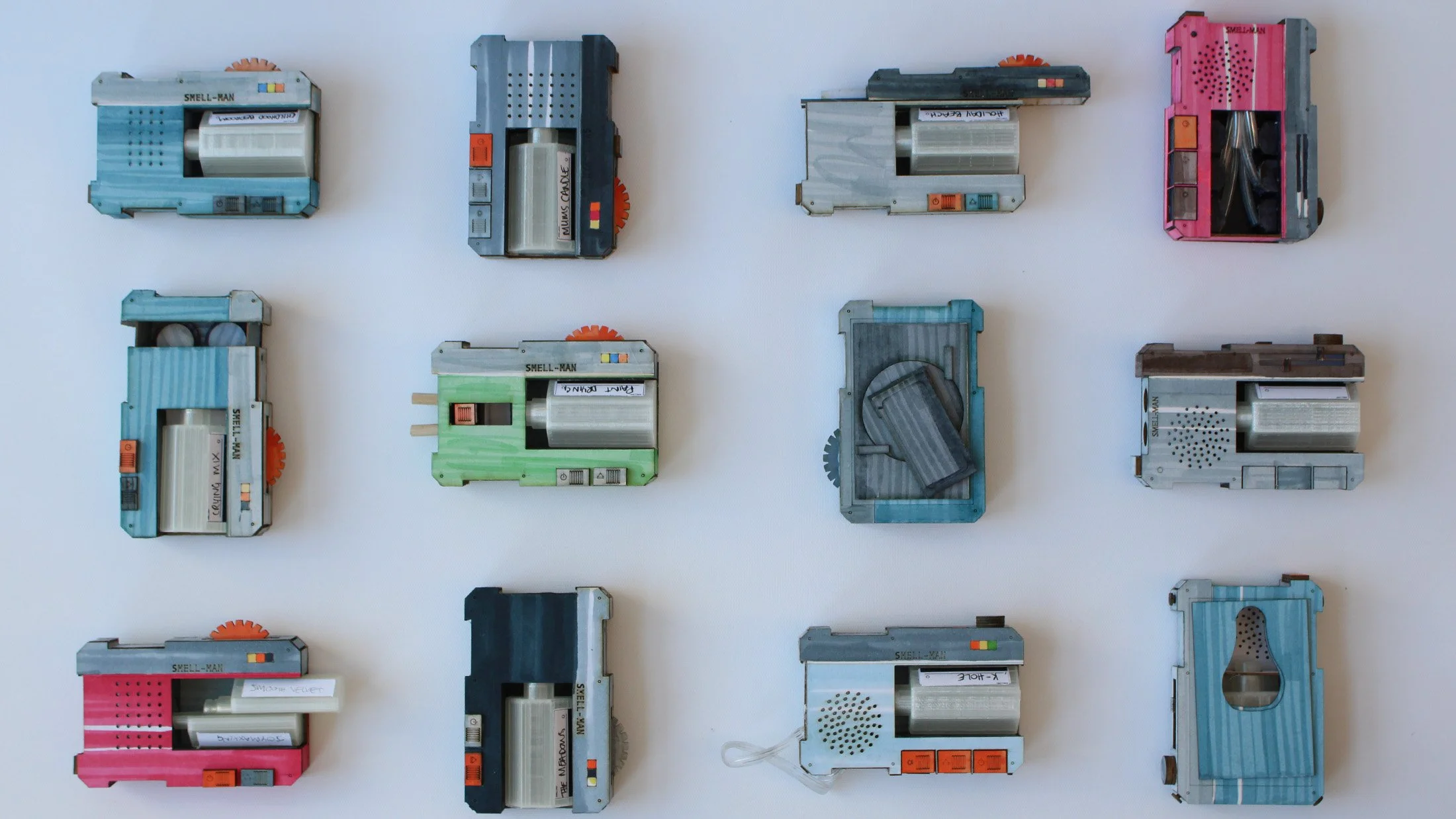 Hero shot of 12 final models, all exhibiting different features that satirically mimic headphone features.