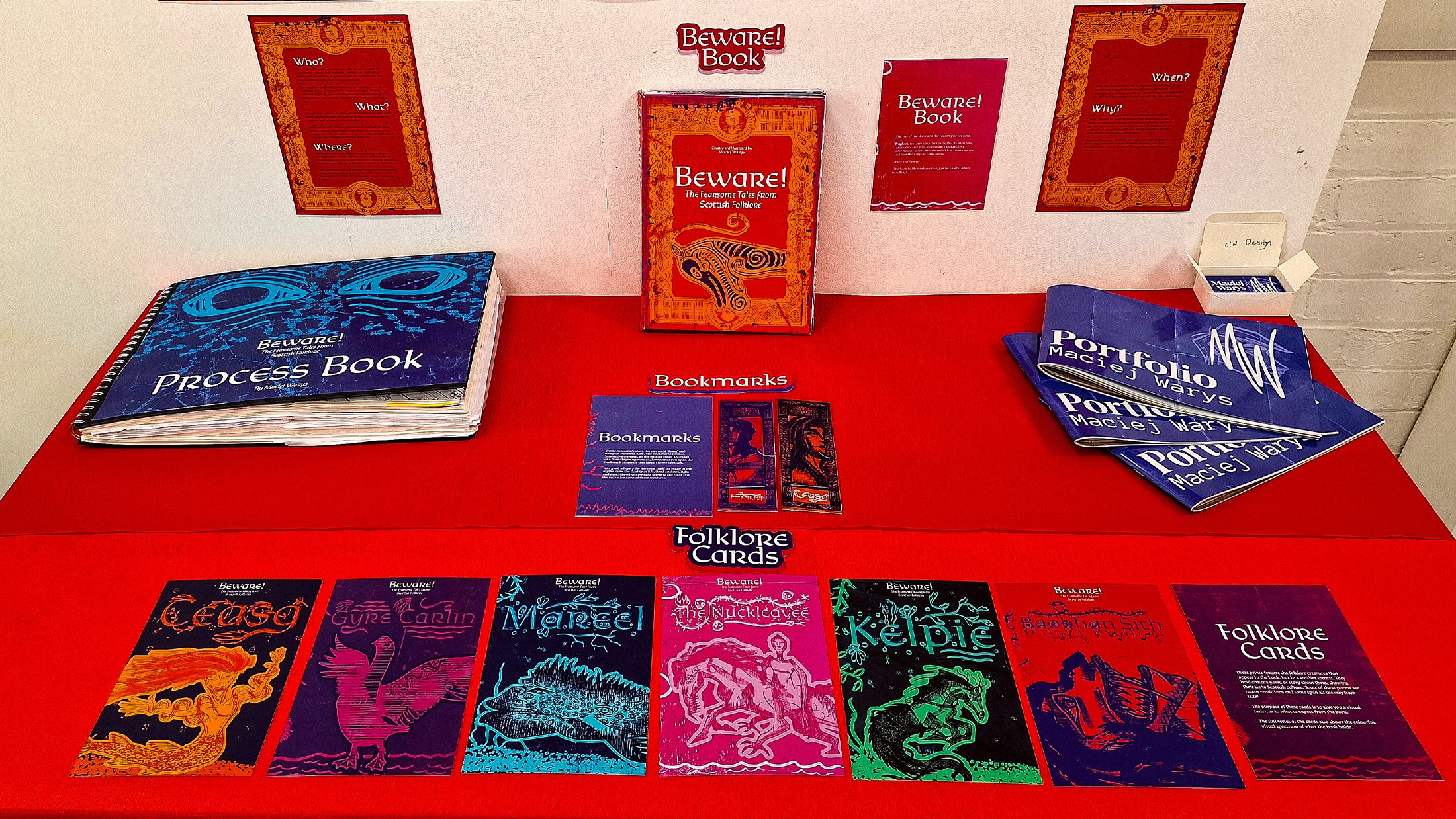 Display featuring the Beware! book, bookmarks and folklore cards. Showing the colourful identity of the project.