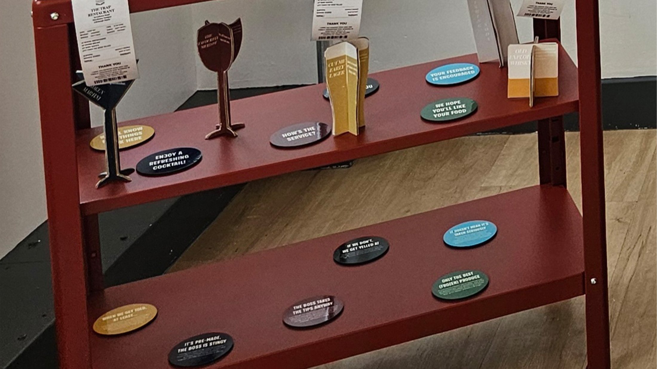 Glasses and coasters displayed on the shelf.