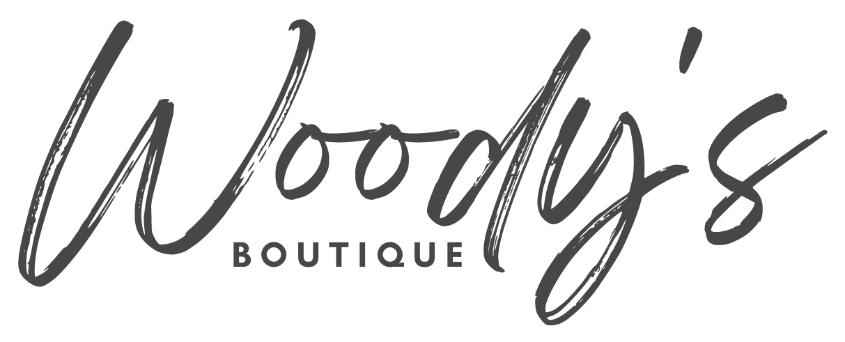 Logo for Woody's Boutique in handwritten script with the word 'Boutique' underneath in smaller capital letters.