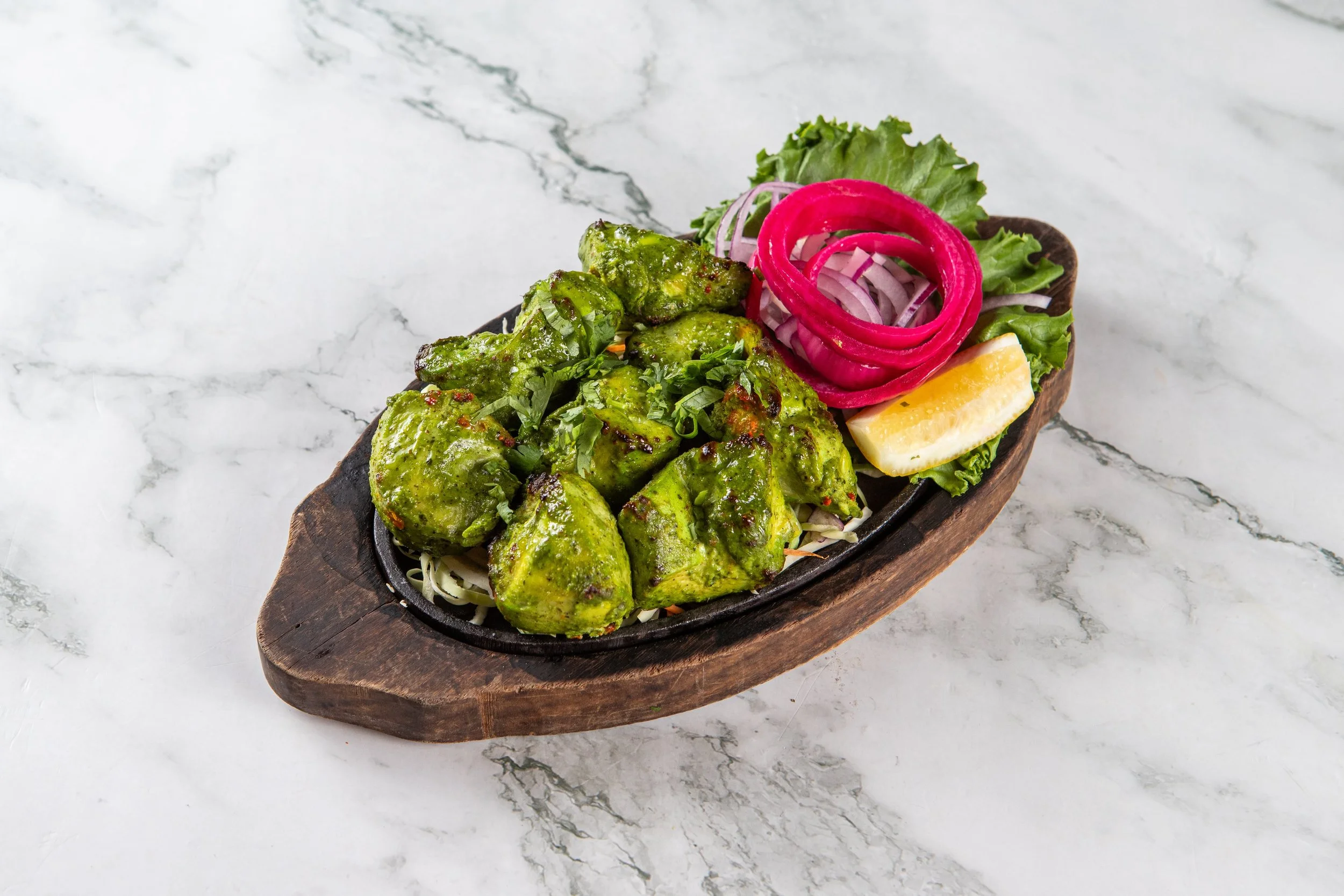 Chicken Hariyali: Tender chicken breast pieces marinated with cilantro, mint, green chilies, yogurt and spices.