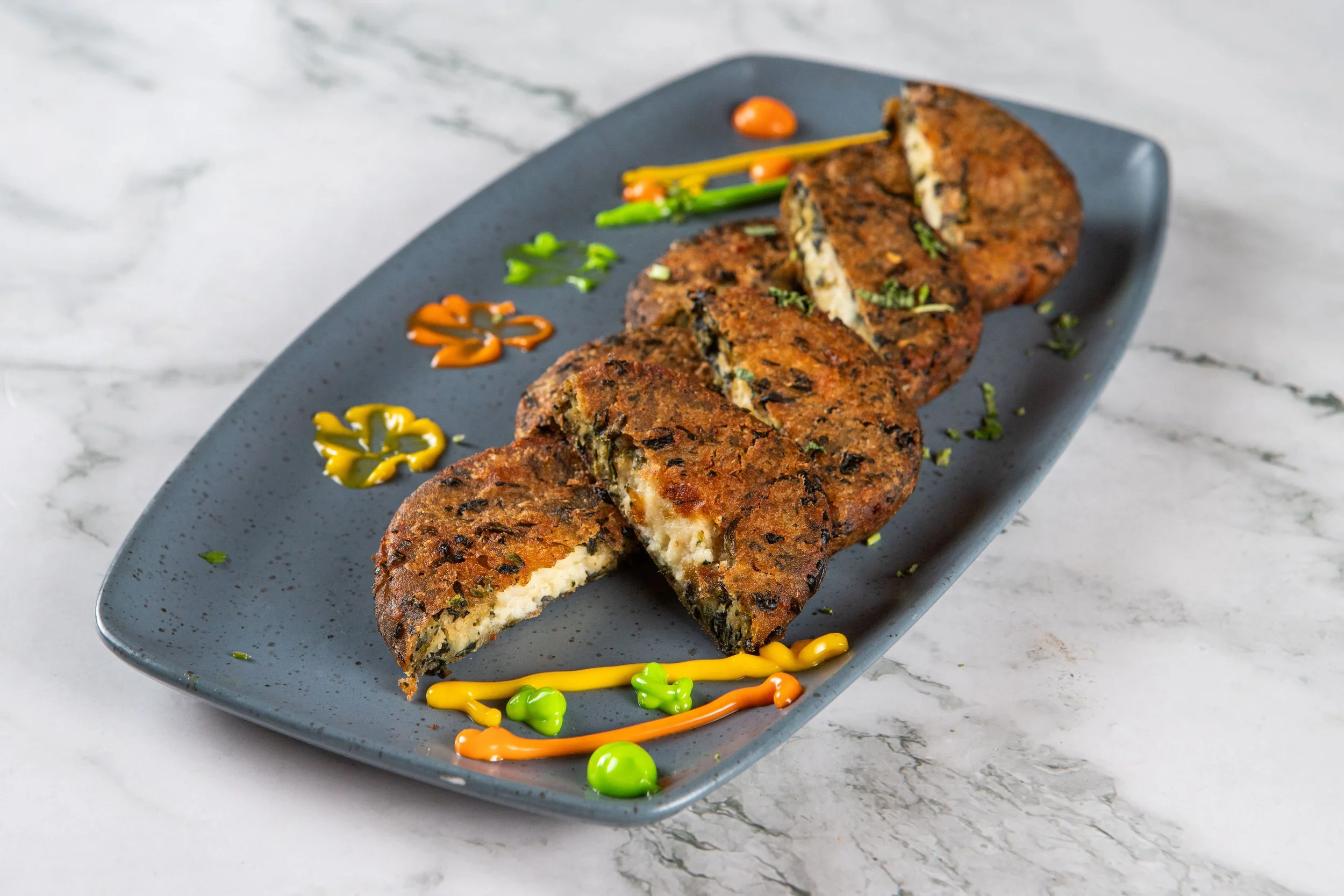 Shaam Savera Kebab: Spinach and potato patty filled with goat cheese and lightly fried. 