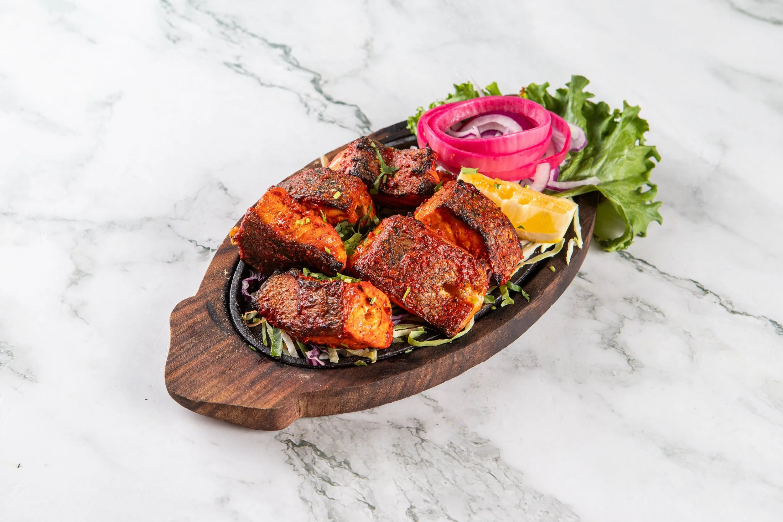 Salmon Tikka: Chunks of seasoned fresh Atlantic salmon grilled in an authentic clay Tandoor oven.