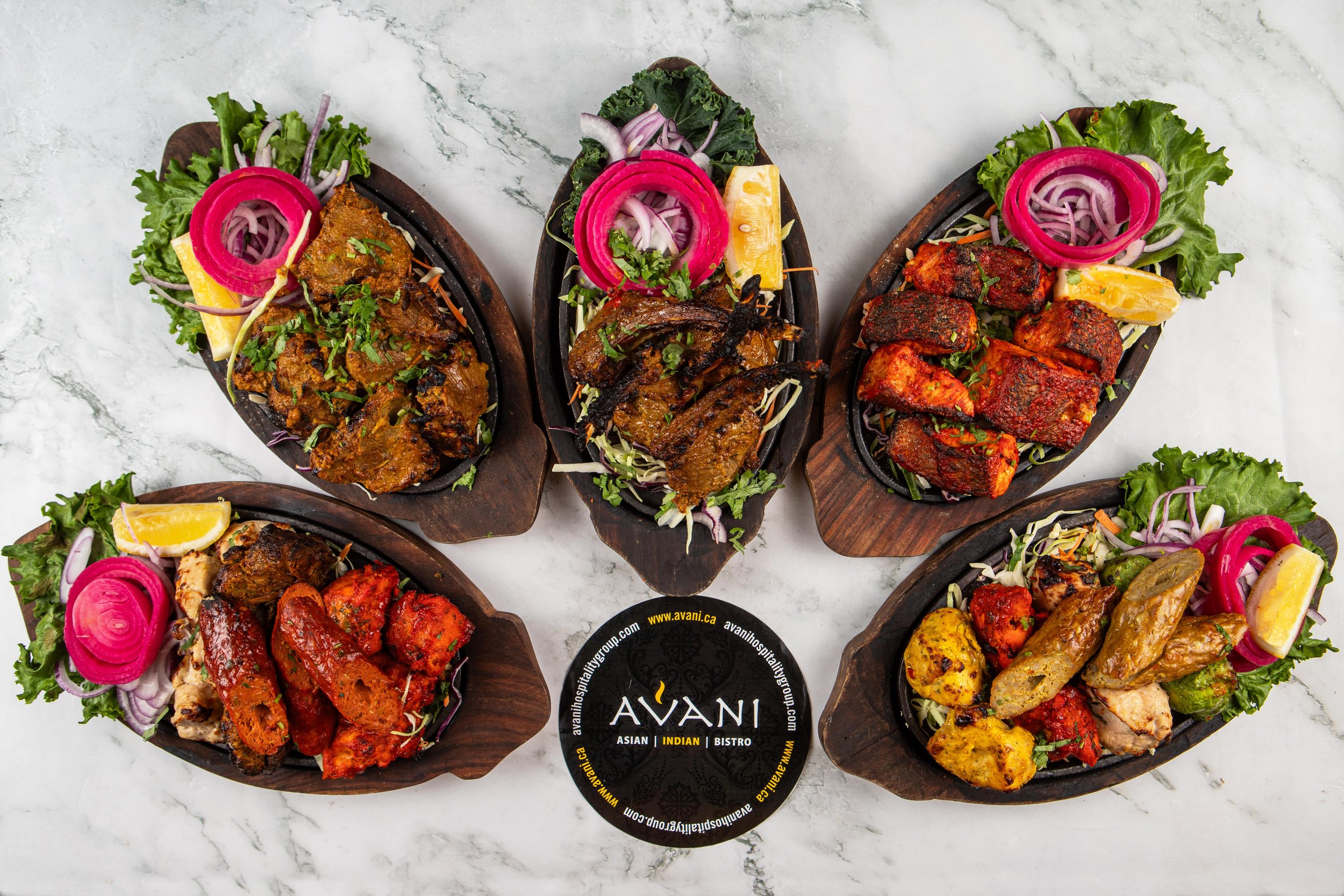 A flower assortment of the non-veg tandoor platters Avani is proud to offer, including our signature Avani Chicken Sampler, tender Salmon tikka, and boldly flavoured lamb and chicken seekh kebab. 