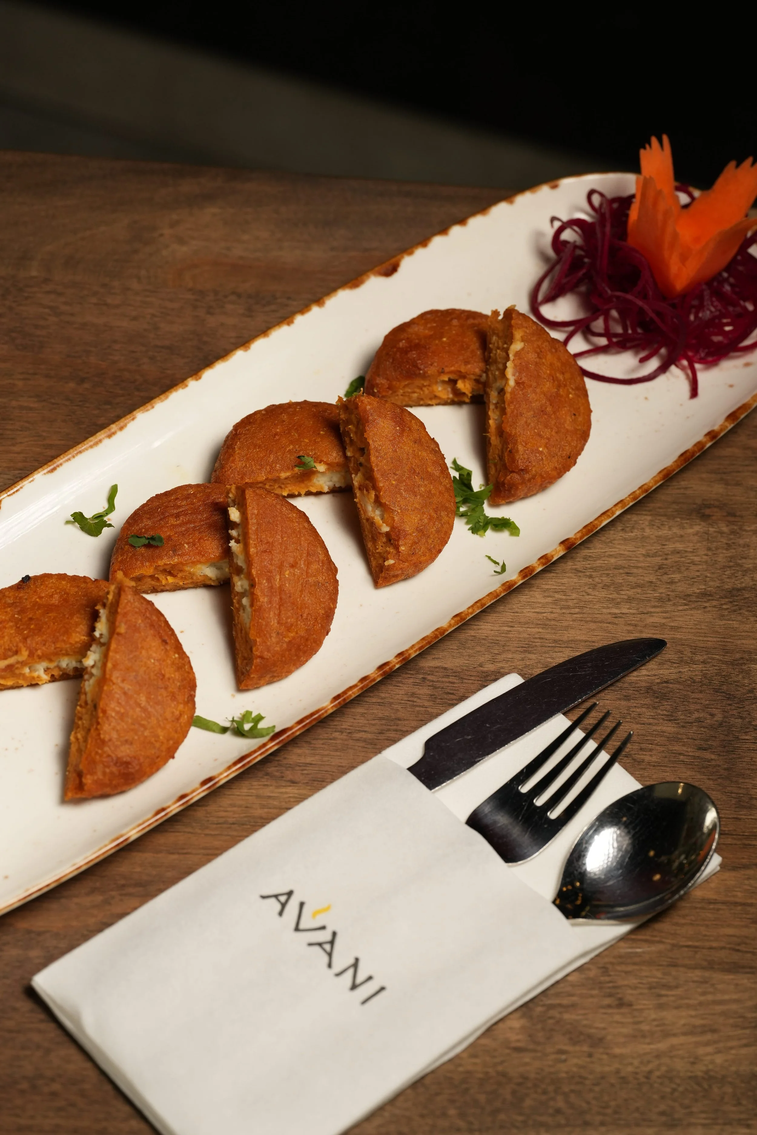 Golden-fried sweet potato coated in warm, aromatic spices, crisp on the outside and tender paneer within. A comforting yet vibrant bite with a perfect balance of sweetness and savoury depth.