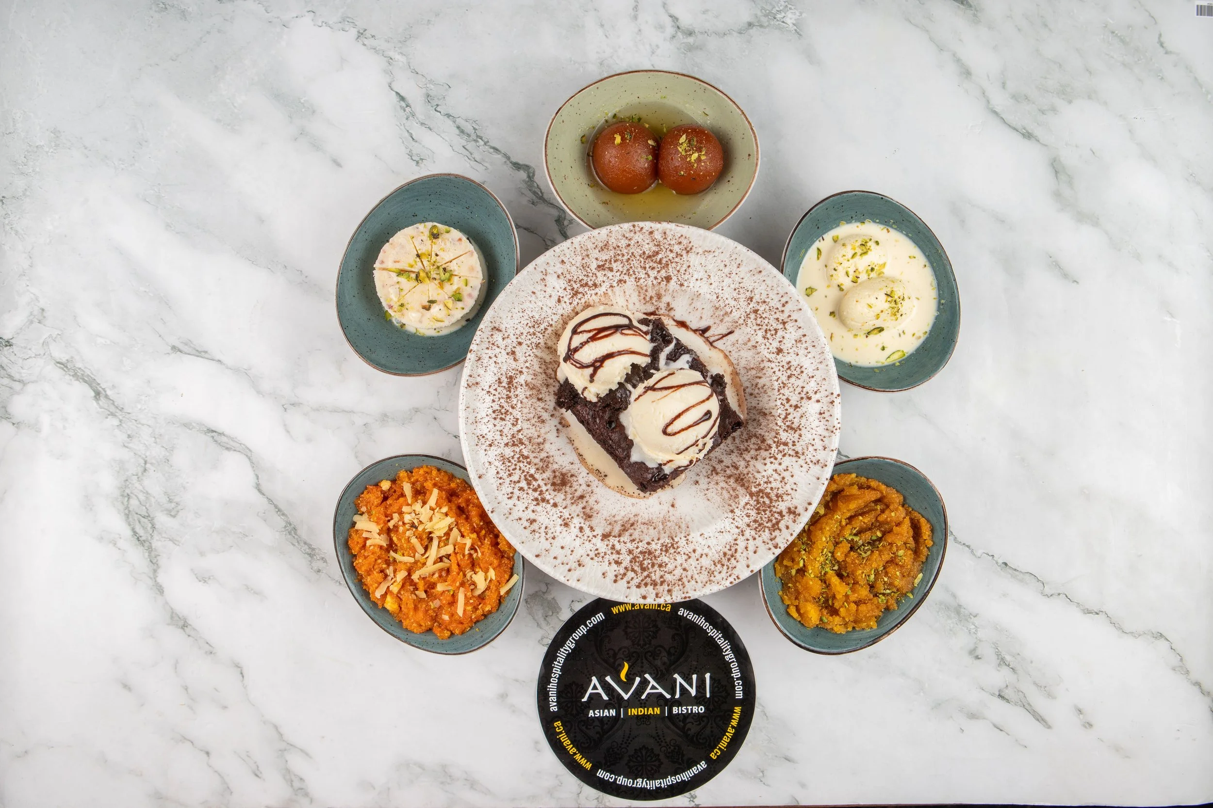 Our assortment of desserts, including traditional ones such as Moong Dal Halwa, Gajar Halwa, Ras Malai, and our signatures such as Mango/Vanilla Fried Ice Cream.  