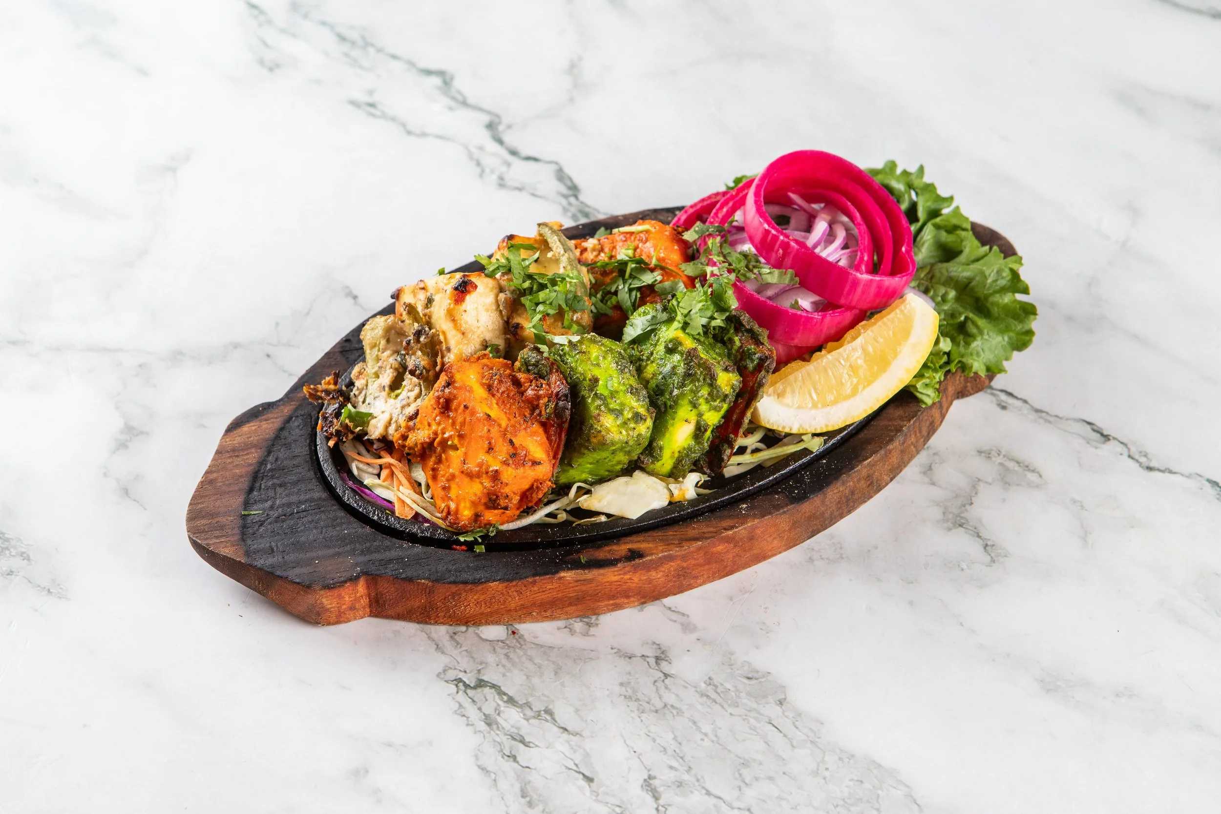 Zaika NCR Paneer Sampler: Chef’s selection of tandoor grilled paneer, achari, hariyali, and kali mirch tikka. 