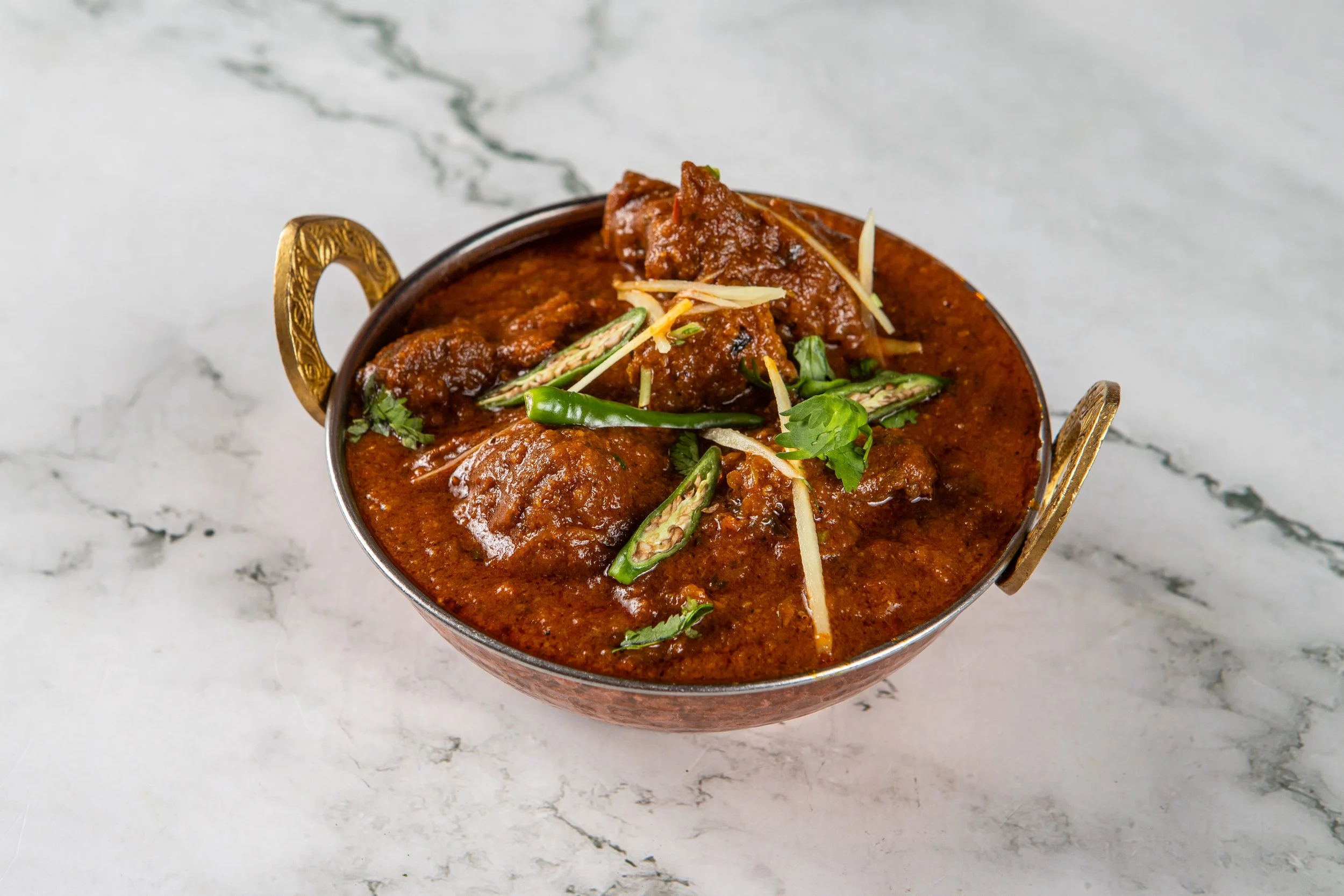 Rogan Josh: An aromatic Kashmiri curry with soft cooked lamb.
