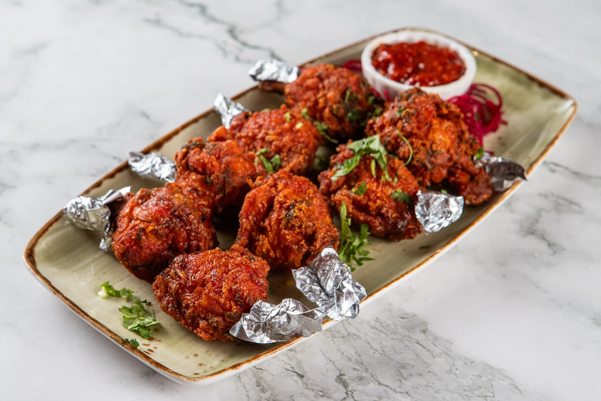 Chicken Lollipops: Crispy, lightly battered, spice marinated chicken wing drumettes