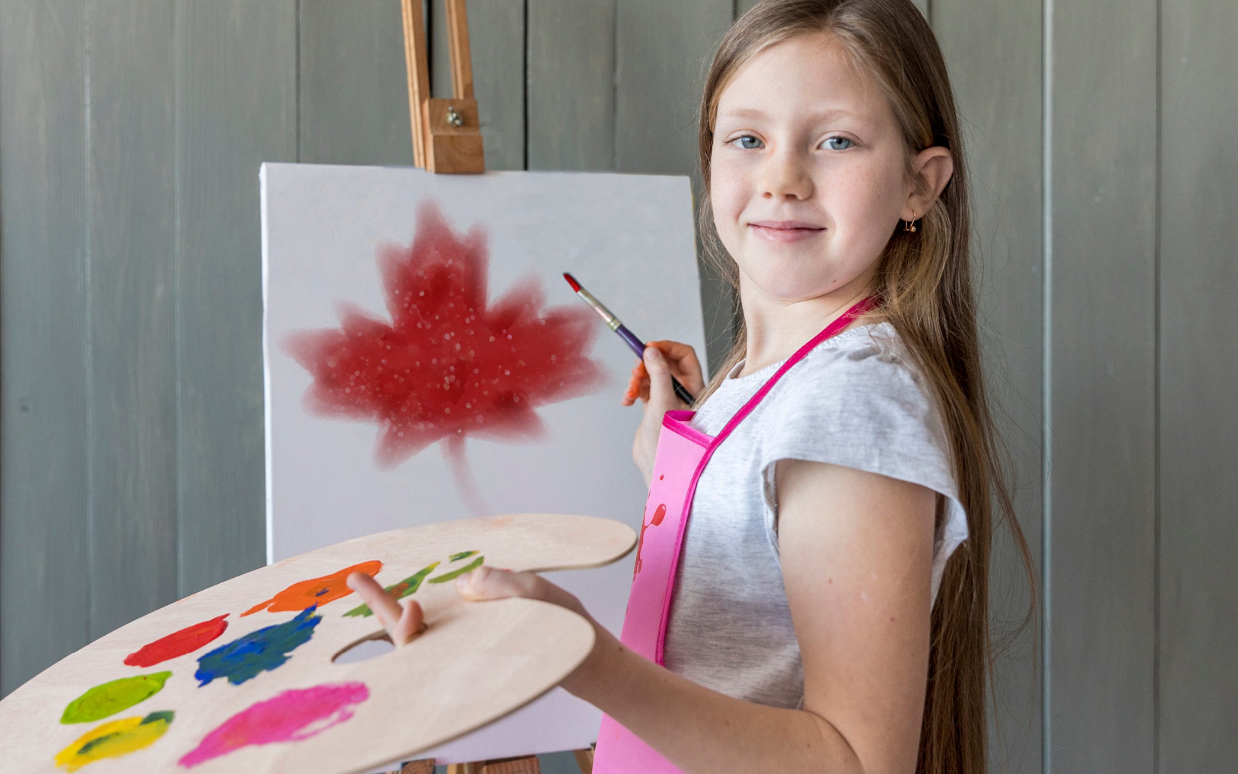 Girl with an easel, paint brush and paint