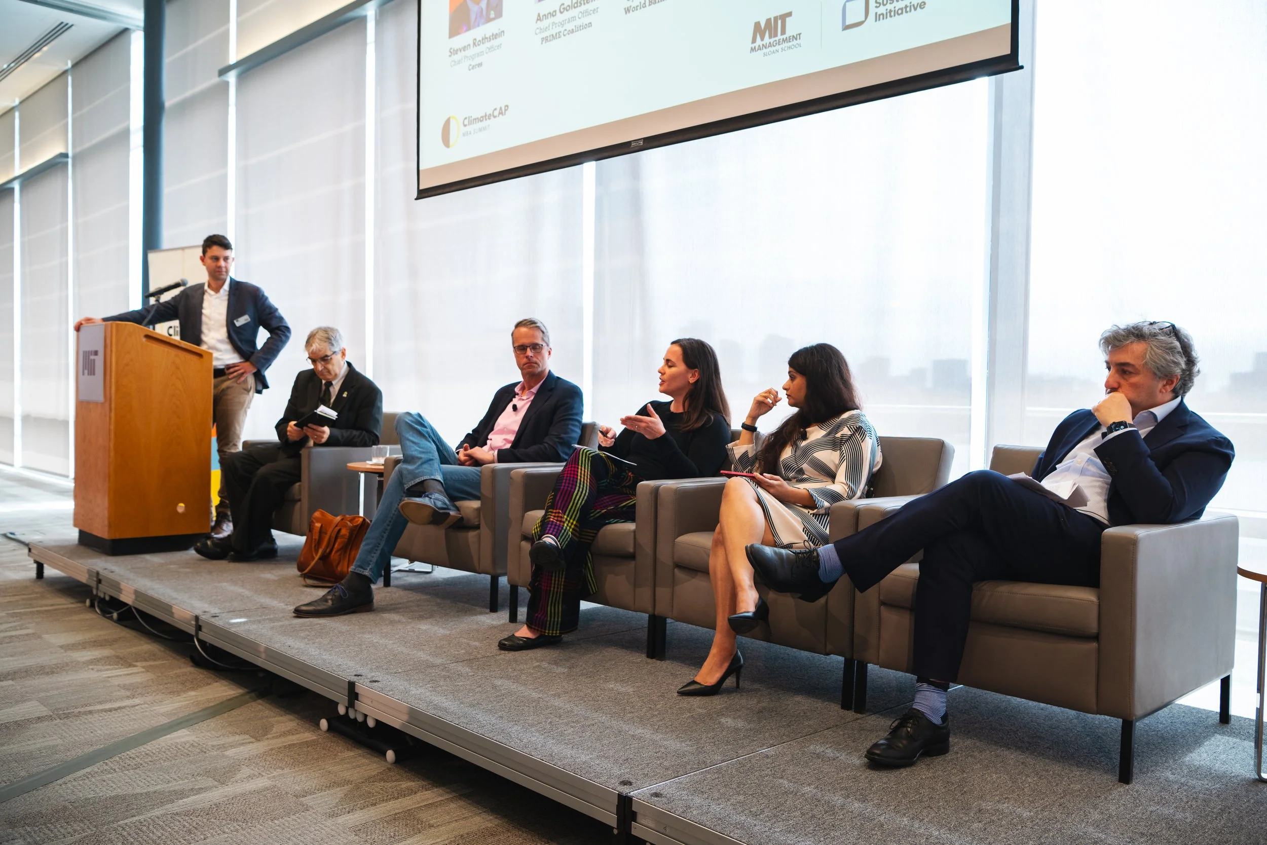 Anna Goldstein speaking on stage at the ClimateCAP MBA Summit