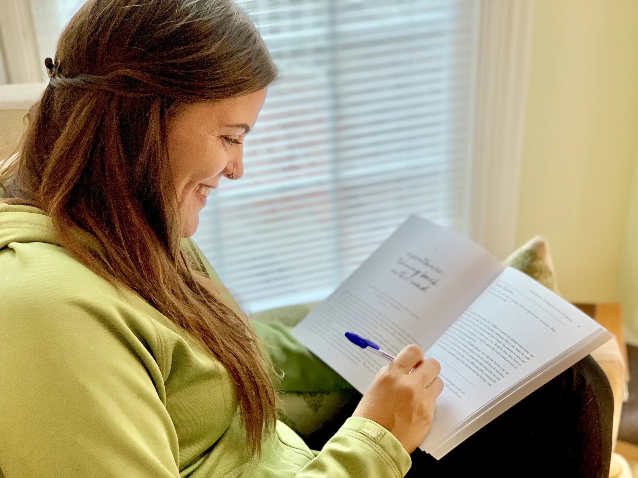 Mom working in her workbook before her online mentoring group