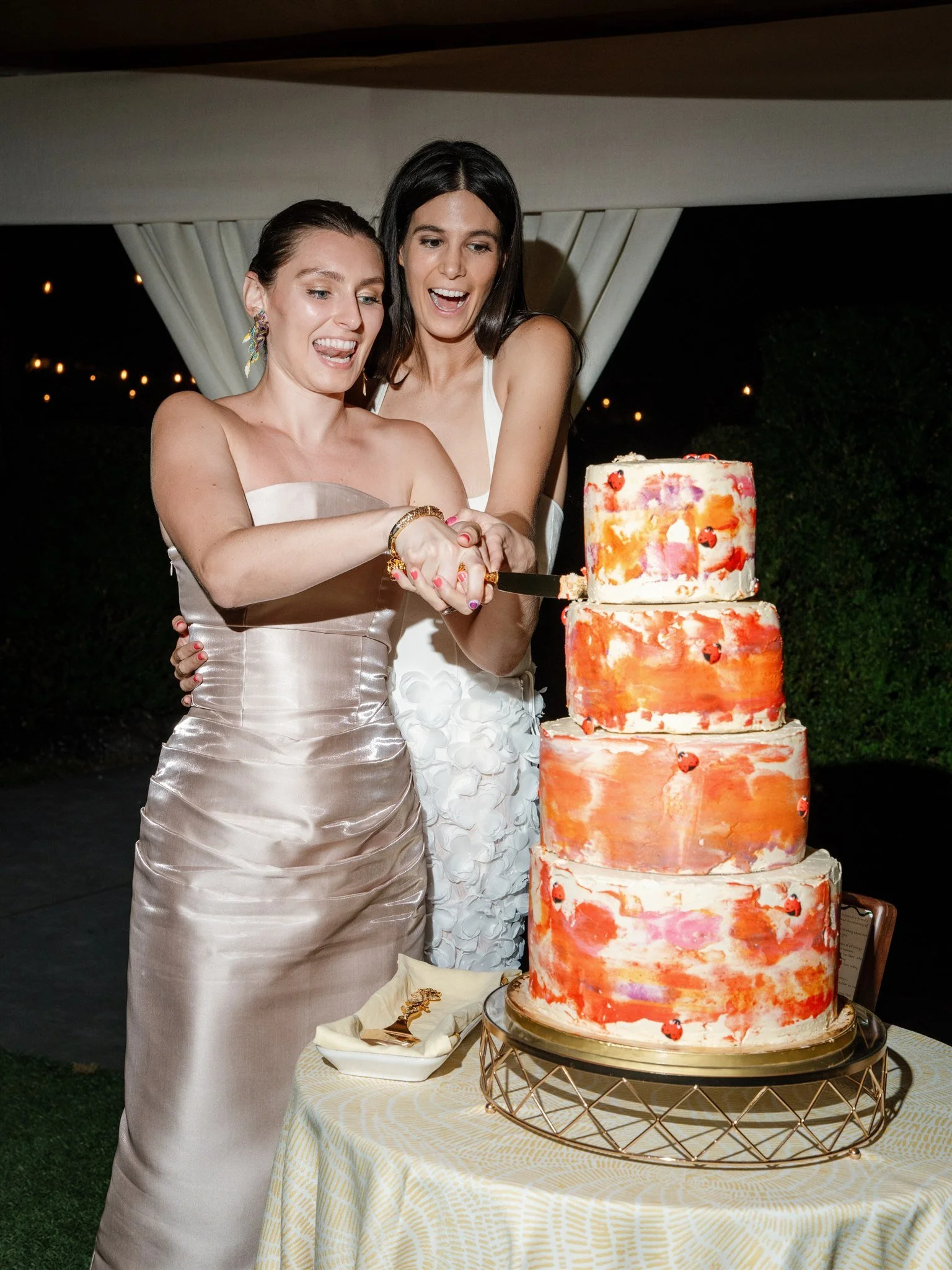 brides cutting colorful wedding cake modern reception beth chapman styling