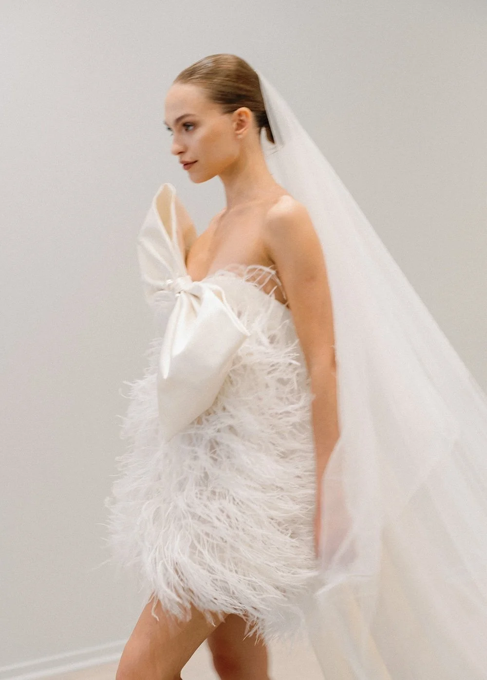Feathered mini dramatic wedding dress from Fall 2026 New York Bridal Fashion Week, Beth Chapman Styling, Monique Lhullier