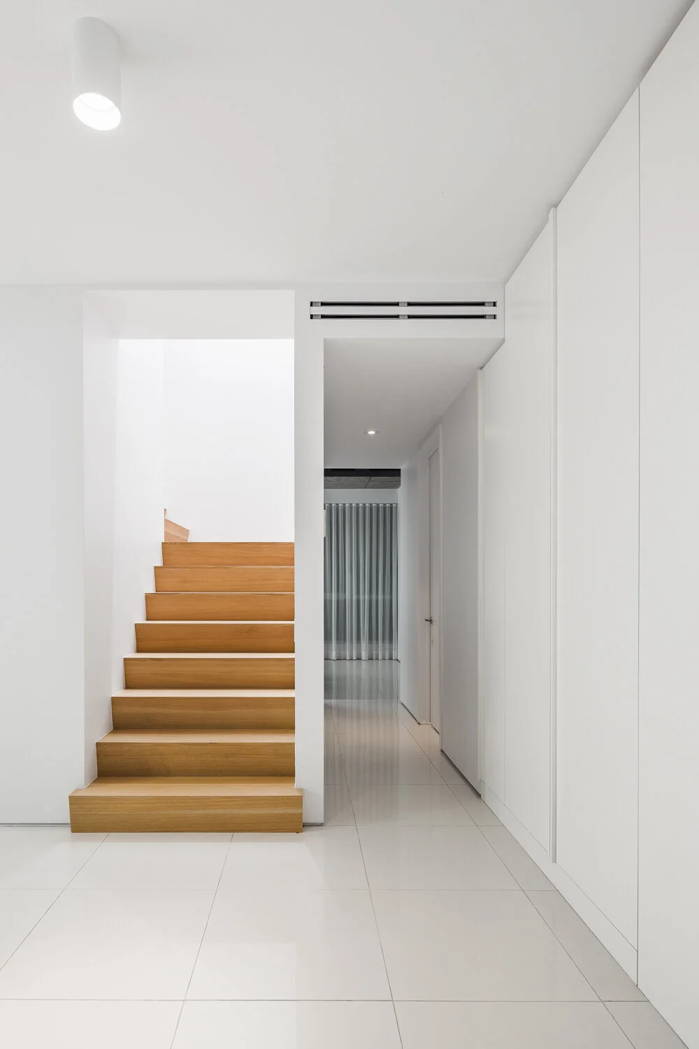 View of the white oak staircase leading upstairs. 