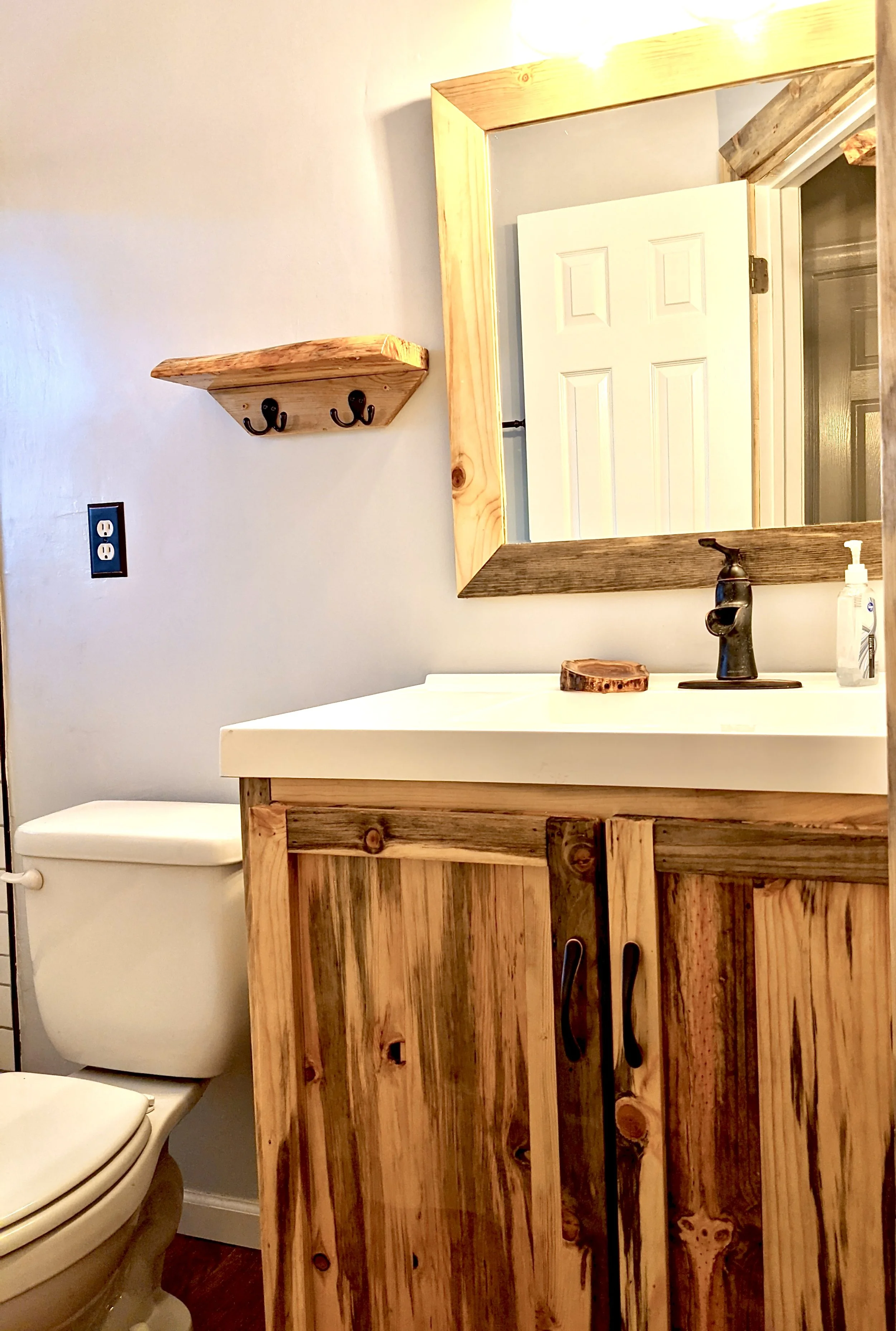 Locally sourced and milled blue stain pine vanity, blue stain pine mirror and floating shelves.  Blue Stain Pine is a waste product in the forest and becomes a fire hazard to Colorado.   It also makes amazing art with the staining from the beetle tha