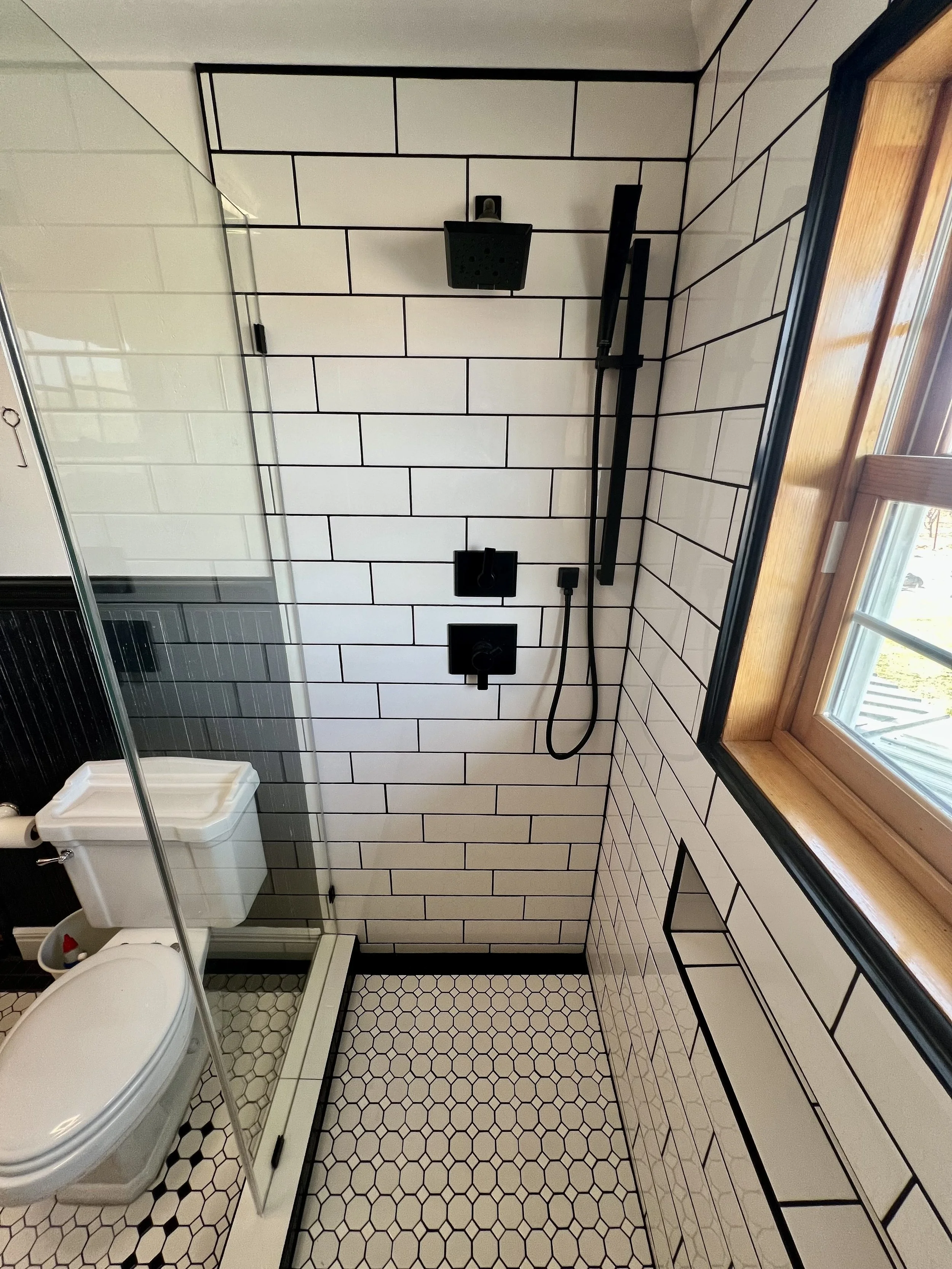 Classic subway tile shower with dual Delta Faucet heads and wands.  This was designed and built so the customers children has a place to shower instead of using a 1900s claw foot tub.  This timeless design uses modern technology and Schluter Systems 