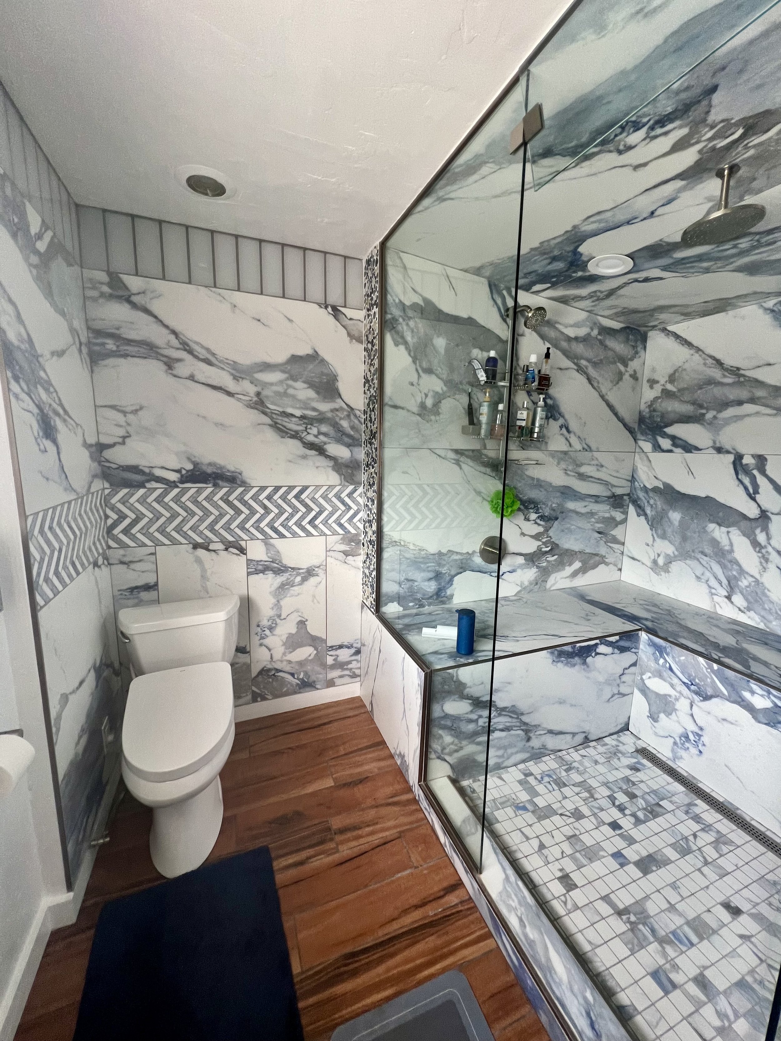Heated floor, heated bidet toilet, steam shower with 6 heads, Schluter Systems waterproofing and a speaker built into the exhaust fan so you can sing while you get steamed.  Fancy enough?  We can build it.  For our client David Fruen.  A friend and b