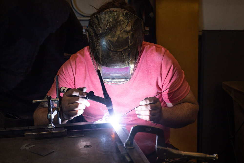 Billy Musselman welding a pivot door